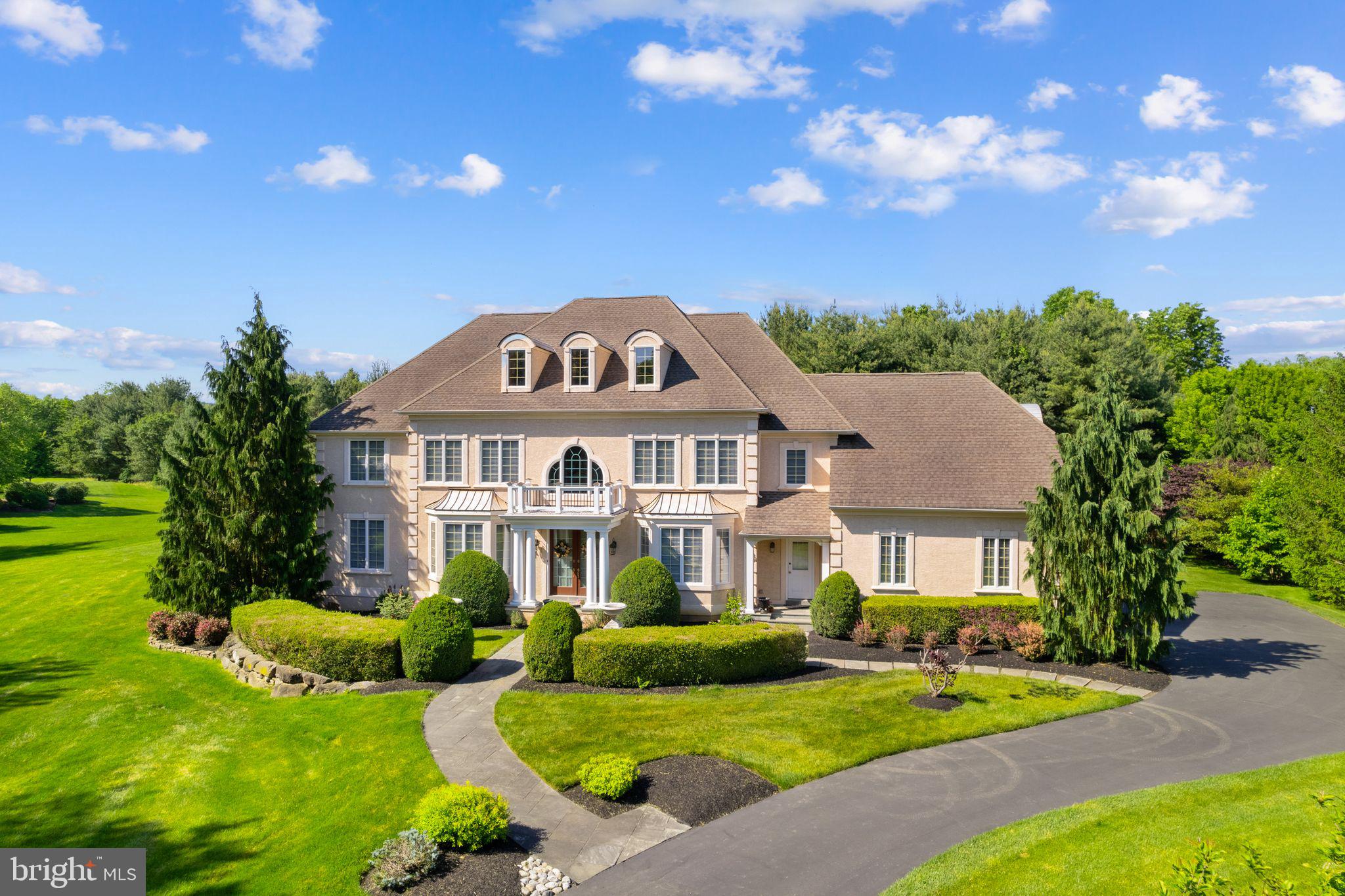 Welcome home to 2209 Corson Lane. This exquisite Georgian-style residence exudes elegance and sophistication. Its classical architecture of beautiful symmetry is enhanced by columns, arches, spacious rooms, and high ceilings. As you enter the gracious 2-story Foyer you are greeted by arched doorways and a wonderful color palette that is true to the Georgian period. The formal Living Room has a stunning faux marble gas fireplace, and pocket doors to a rich toned study with built in cherry bookcases. The Formal Dining Room with its beautiful moldings and Bay window is the perfect spot for sit-down dinners. Moving past the turned staircase is the grand Great Room made the more spectacular by its central and ornate gas fireplace and floor to ceiling windows that flood the room in light. The kitchen is a chef’s delight featuring Wolf range, Subzero refrigerator, Asko dishwasher, Dacor oven and warming tray, microwave, and range hood. It is enhanced with beautiful cabinets, countertops, backsplash, and a large island that seats four and is an ideal gathering spot. A Butler’s Pantry makes formal entertaining a breeze with an extra sink, wine frig and wine racks. Upstairs offers a wonderful retreat. The primary Bedroom is complete with a large sitting room, 3 closets (1 large walk-in) and a spa like bath with dual sinks and vanities, jacuzzi tub and updated shower with rain shower head creating the feel and sound of a gentle summer rain. There is a lovely en-suite Bedroom and two additional Bedrooms with a shared Hall Bath. All Bedrooms have ceiling fans and gleaming hardwood floors. The walkout lower level is unfinished with high ceilings, rough-in for a bath and endless opportunities. There are many newer mechanicals: HVAC (2), Water Heaters (2), Sump Pump, and Whole House Generator. Outside, enjoy the privacy of this beautifully landscaped one acre lot. Located on a bucolic country road yet minutes to New Hope, Doylestown and all that Bucks County has to offer. Blue Ribbon Central Bucks Schools and an easy commute to NJ, Philly, or NYC.