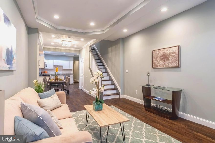 BEAUTIFULLY DESIGNED PATTERSON PARK RENOVATION WITH OVER 1,700 SQ. FT. OF LIVING SPACE!  Open floor plan featuring wood floors throughout the main level, spacious living room w/ tray ceiling, large dining area, gourmet Chef's kitchen w/ ss appliances, granite counters, and tons of cabinet space, main level bedroom suite w/ full bath, upper level with 2 large bedrooms and 2 full baths, fully finished basement w/ a family room or 4th bedroom and 4th full bath, and a private rear patio that can easily be converted to a parking pad!  Pack your bags and move right in!