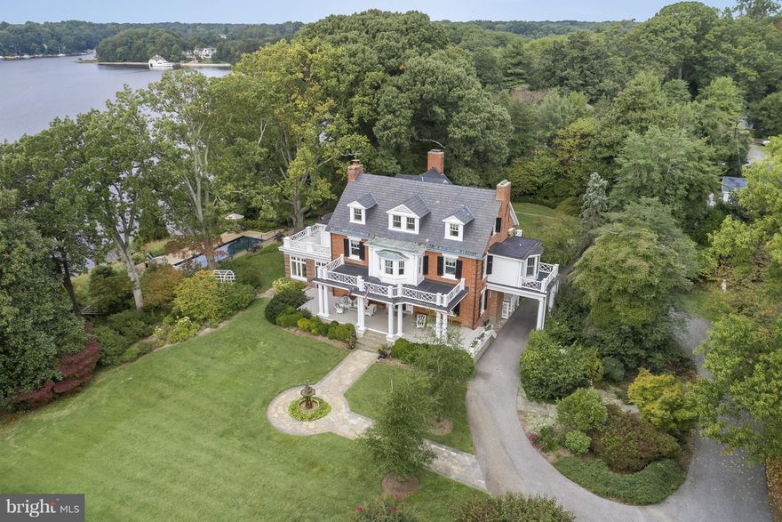 Prominently sited on nearly 3 acres of elegantly manicured grounds with mature gardens and water views. Stately brick manor, rare boat house, two deep water piers, waterfront salt water pool, terraced flagstone walks, distinctive stone gazebos & carriage house. Interior of house is complimented by high ceilings, multiple fireplaces, and original victorian details. Appraisers call LA for details.