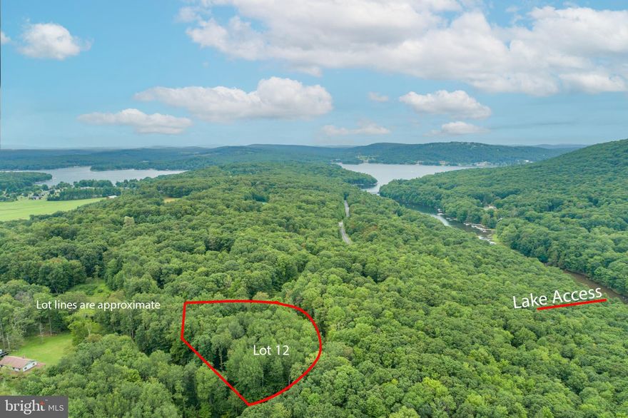 Escape to the mountains with this 1.51 acre homesite featuring lake access and scenic natural surroundings.  Conveniently located near multiple state parks, this property offers the opportunity for year-round recreation including hiking, skiing, golf, boating, kayaking, fishing, wildlife watching and more.  The community of Meadow  Mountain Run has 7+ acres of common land with a lake access area to launch your canoe or kayak.  Septic approved for 4 bedrooms.  A perfect canvas for your dream home or vacation escape!