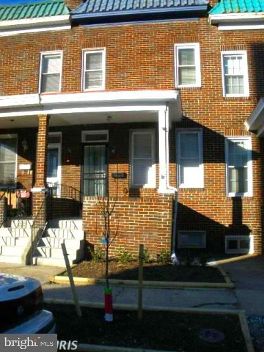 A Classic Baltimore Porch Front Townhome, located in  a row of porch fronts.  Good bones are evident throughout. The property was renovated in 2013 and could use some cosmetic updating i.e. paint. The traditional Baltimore Townhome layout has been retained.  It has 2 bathrooms and 3 bedrooms. Bedroom number 3 and bathroom number 2 are located on the lower level.   The floors are hardwood with inlaid trim and the bathrooms feature ceramic tile. A decent sized rear fenced yard offers additional recreational space. The most recent sale on this block, albeit for a recent renovation, was 350k.  This would be ideal as a starter home