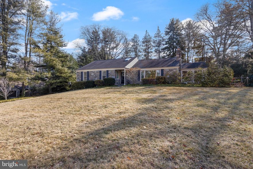 713 Newtown Road in Villanova is a jewel box on the Main Line, offering timeless charm with modern updates. This beautifully renovated ranch home, set on a picturesque one-acre lot in sought-after Radnor Township. Built from solid Mica stone, the home is in excellent condition and ready to enjoy.
A bright, open floor plan welcomes you, where a recently added support open concept kitchen and family room creates a seamless flow between the kitchen, dining, and living areas.The foyer, flooded with natural light from a skylight, sets an inviting tone. Throughout the main living areas, refinished custom oak floors and detailed millwork add warmth and elegance. The fully remodeled kitchen is a chef’s dream.Custom white and gray cabinetry pairs beautifully with white quartz countertops featuring striking gray veining. A center island with a prep sink and seating for four makes both cooking and entertaining effortless. High-end appliances include a Wolf six-burner range, a 42” Sub-Zero refrigerator, a Bosch dishwasher, a GE Advantium oven, and a Best 10” exhaust fan. Sunlight floods the space from a skylight above as well as a glass door leading to the backyard, creating a bright and inviting atmosphere. Just off the kitchen, a sophisticated wet bar enhances convenience and style. Custom white cabinetry with open shelving, glass-front doors, and standard storage is complemented by black soapstone countertops and a herringbone tile backsplash. A built-in beverage refrigerator and sink make entertaining easy, while a desk area offers practicality. A peninsula island with seating provides a natural gathering spot, while the space flows seamlessly into the living room, where deep-silled windows fill the room with natural light. A beautiful wood-burning fireplace with a detailed mantel and herringbone tile surround serves as a focal point.
A true highlight of this home is the updated sunroom, now a year-round retreat with the addition of heating and A/C. This 13’ x 18’ space added 234 sq. ft. to the main level and features oversized insulated sliding windows. Whether unwinding with a book, watching a favorite show, or simply enjoying the changing seasons, this room offers a serene escape.
Three spacious bedrooms and two renovated bathrooms are located off the main living areas. The primary suite features a walk-in closet and an updated en-suite bath, while the two additional bedrooms offer ample space. The third bedroom is currently used as a home office/den, offering flexibility. A second beautifully renovated bathroom completes this level. Additionally, the floored attic presents an opportunity for future expansion.
The newly finished lower level adds 578 sq. ft. of living space, including a generous bonus room (20' x 12.5'), a dedicated laundry room (10' x 12'), and a climate-controlled wine cellar (8' x 8'). A 12' x 12' salon with plumbing was designed for the current owner’s use, providing additional flexibility.
The picturesque backyard features an updated paver patio and an elegant slate walkway, offering a private setting with mature landscaping. In the spring, rhododendrons burst into bloom, while surrounding trees attract a variety of birds and wildlife.
Additional upgrades include a new insulated door and opener for the attached two-car garage, newer insulated windows, high-efficiency gas heat, a new central A/C system (installed six years ago), and 200 AMP service. Basement and sunroom have added HVAC systems.
Ideally situated on the Main Line, this home provides quick access to the Blue Route (I-476), the Villanova train station (less than two miles away), and a wealth of shopping, dining, and recreation options. Enjoy The Willows Park or the 4.8-mile Radnor Trail, both offering walking trails. Located in the highly sought-after Radnor School District, this home is a rare blend of charm, warmth, and modern convenience.
*(square footage is estimated from public records and the attached floor plans).