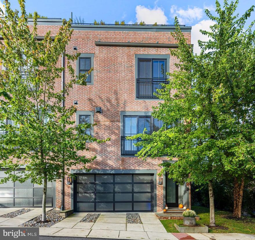 Showings start Thursday 9/25! The townhomes at Plant & Willow take their cues from the character of old factories and warehouses—spaces once purely utilitarian, now celebrated as design icons. This community leans fully into the “Industrial Chic” aesthetic, highlighting expansive windows, dramatic ceiling heights, exposed brick, and architectural post-and-beam details. At 207 Willow Avenue, a 3-story END-unit townhouse, you’ll find all of this and more—plus spectacular views from oversized windows and the option for future elevator installation. From the moment you arrive, the striking brick façade and sleek garage doors set the tone for what awaits inside. Step through the front door and prepare to be impressed by floating staircases, designer lighting, impeccable finishes, and sunlit spaces on every level. The entry level provides garage access with smart wall organizers, a utility/storage closet, and a spacious 3rd Bedroom which could also be used as a Study/Office. This room also has 2 closets and an en suite 3rd Full Bathroom with a floating vanity and designer tiled shower. The ground floor Hallway features upgraded tile flooring (chosen over the builder’s standard concrete) for a clean, polished feel.  There is ample space under the stairs for exercise gear, a desk, or cubbies.  Closets on each level were aligned to make this home ELEVATOR-ready and the HOA dues are very LOW compared to most turn-key communities.  Ascend to the main level,, which offers true loft-inspired living. Here, the gourmet Kitchen shines with honed black counters, open shelving, lift-up glass cabinets, a walk-in pantry, and an enviable appliance package with Thermador 4-burner gas cooktop with griddle, wall oven, microwave, and dishwasher plus a KitchenAid French-door refrigerator 
The island features breakfast bar seating for casual dining, or enjoy hosting family and friends in the spacious Dining Area.  The Living Room adds even more style with an exposed brick wall, sleek gas fireplace, and treetop views framed by oversized windows. A Powder Room completes this level, perfect for guests. Upstairs, hardwood floors continue throughout. The spacious 2nd Bedroom offers large windows, built-in shelving, and track lighting, while the Hall Bath echoes the sleek design of the lower levels. The Laundry Room is oversized with plenty of storage space. The Primary Suite is a retreat in itself—boasting tree-top views, two walk-in closets with custom organizers, and a luxurious Bathroom featuring a floating double vanity, oversized tile shower with multiple shower heads and jets, and modern lighting. The rooftop deck is the showpiece: finished with wood decking, planter boxes, accent lighting, and a natural gas fire pit. It’s the perfect backdrop for sunset gatherings, summer barbecues, or quiet evenings under the stars. Additional upgrades set this home apart: all closets include custom built-ins, recessed lights are smart-controlled, and premium Shade Store window treatments are already in place. Every design choice reflects a refined taste that the next owner will enjoy for years to come.
Only 3/10 mi. from Wayne Train Station!  Take N. Wayne Ave. to R/Pennsylvania Ave. to L/Plant to L/Willow.