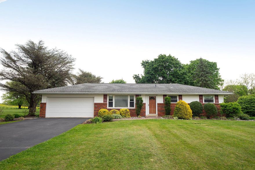 Nestled on a generous 0.94-acre lot, this charming ranch-style home exudes warmth and comfort.  This well-maintained residence combines classic design with modern updates. Step inside to discover a thoughtfully designed interior that emphasizes functionality and style. The heart of the home features an inviting eat-in kitchen, perfect for casual dining and entertaining. Natural light pours in, creating a cheerful ambiance. The kitchen is ready for your personal touch, offering ample space. With two bedrooms and two full bathrooms, this home provides a comfortable layout that caters to both relaxation and privacy.  The bathrooms are well-appointed, ensuring convenience and comfort for you and your guests. The full basement is partially finished with a gorgeous bathroom and additional storage space.  The exterior of the property is equally impressive, featuring a classic brick and vinyl siding façade that adds to its curb appeal. The attached front-entry garage provides easy access and additional storage, making everyday life a little more convenient.  The large detached garage is perfect for the car enthusiast with water and a mini-split to make the area more comfortable all year around