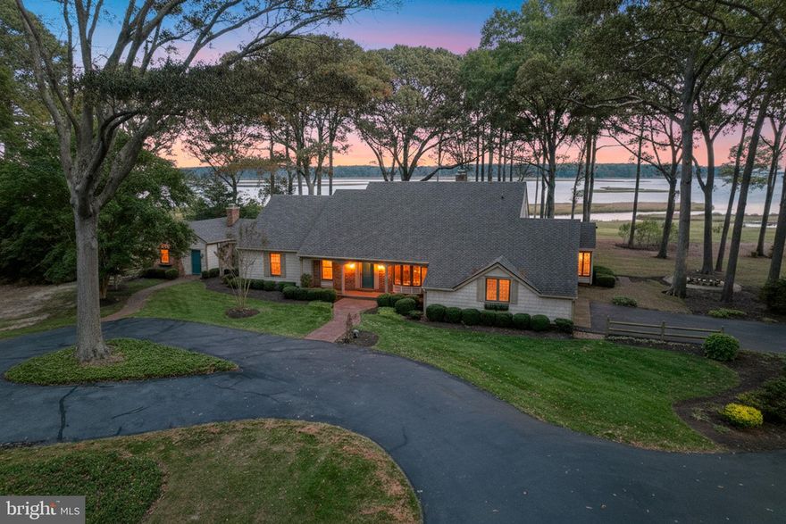 An extraordinary waterfront retreat offering rare privacy, expansive acreage & breathtaking views along Herring Creek, a tributary to Rehoboth Bay. Situated on an impressive 5.45-acres with approximately 1,300 feet of water frontage, this 3 Bedroom & 2 Bathroom Coastal-Colonial style home delivers a one-of-a-kind waterfront lifestyle. Step inside and you will be impressed with the thoughtful design and layout of the home offering spaces that were built for gathering, relaxing and taking in the water views. Notable interior features include a Primary Suite featuring & en-suite bath, a Formal Dining Room with Built-Ins, Kitchen w/Center Island & Eat-in nook, a spacious Living Room w/Bay windows, a Family Room w/Fireplace & Vaulted Beamed Ceilings and a generously sized Three-Seasons room with breathtaking views. You will also find a Bonus Room used previously as a craft room and an Office with private entrance. The Primary Bedroom, Living Room, Family Room and Three-Seasons Room enjoy serene water views! A staircase in the garage leads to unfinished Attic Space with room to grow. New roof around 2022! New HVAC August 2025! Venture outside to the Gazebo with Deck overlooking panoramic water views, surrounded by mature trees and open, protected lands for ultimate seclusion. There is not yet a dock on this property but all of the surrounding properties feature docks-offering exciting potential for the future. In the meantime, enjoy canoeing, kayaking & fishing off of your private lot, with access to the community dock and boat ramp. Located in the desirable Winding Creek Village community, just minutes from Route 24 and 8 miles to Lewes & Rehoboth beaches, award winning dining, and tax free shopping of Sussex County.