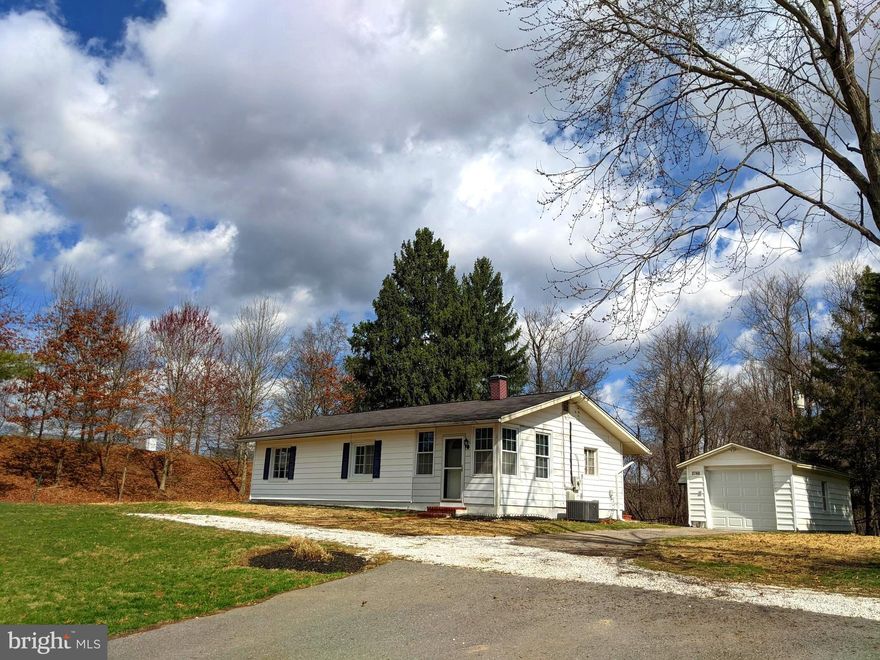 This small solid built Rancher is exceptionally well & uniquely situated!  Located in the highly sought after Hollifield Station neighborhood surrounded by homes with values starting in the mid 600K's and up and exempt from the HOA fees! The oversized (almost 1/2-acre) level lot sits back 250 feet from the street, with a totally quiet private backyard surrounded by trees & backing up to Forest Preserve!  This home has 2 bedrooms, 1 full & 1 half baths with a detached 1 car extra-long garage with storage attic space.  Updates include the roof and chimney, oil furnace heat and central air with a smart thermostat, some replacement windows, front and back doors and fresh neutral paint!  Convenient location with I-70 only minutes away & quick access to the Baltimore Beltway (695), BWI, downtown Baltimore and DC! A little piece of Paradise!