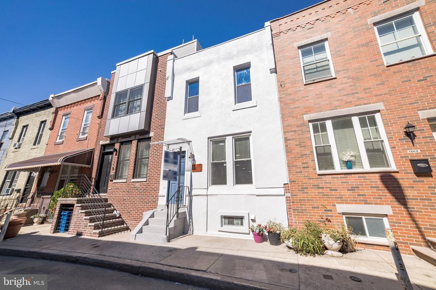 Beautifully renovated home steps from Wharton Square Park!   This property is nestled in a quickly developing section of Point Breeze, just south of Graduate Hospital.   Walk to local shops and restaurants in each neighborhood with ease - American Sardine Bar, Dock Street Brewery, Sidecar, and Los Camaradas to name a few.  Enjoy an array of close conveniences along Point Breeze & Washington Ave, as well as the Fresh Grocer a short trip away.  Fully renovated in 2022, this home offers open concept living with rich dark espresso-toned hardwood floors throughout.  The first floor includes a modern full bathroom with shower stall and an eat-in kitchen upgraded with gray cabinetry, quartz countertops, stainless steel appliances, and access to a spacious back yard.  The full basement is partially finished with laundry area and bonus room.  The second floor offers 3 bedrooms and a modern full bathroom with tub.   Last but not least, a staircase has been built with doorway access to the roof.  This level has the potential to be converted to a 3rd floor master suite and/or roof deck by the new owner in the future.  The sale includes architectural plans for the potential 3rd story addition.   This home is truly one that you can grow into for years to come.  Move-in now and develop the space to produce even more value when the timing suits you.  Schedule your appointment today!