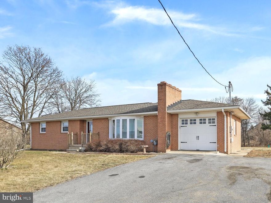 Welcome to 79 Primrose Drive — a well-maintained brick ranch offering comfortable one-level living in an established Martinsburg neighborhood. This home features a functional layout with warm, inviting spaces and thoughtful updates throughout.

The kitchen offers abundant solid wood cabinetry, natural gas cooking stove and stainless steel appliances, opening seamlessly to the dining area—ideal for everyday living and entertaining. Hardwood floors and natural light add to the home’s welcoming feel.

The main level includes comfortable bedrooms and a full bath, while the lower level provides additional space with exterior access—perfect for storage, hobbies, or future finishing. Outside, enjoy a spacious yard with room to relax, garden, or entertain, along with a driveway and attached garage for added convenience.

Centrally located near shopping, schools, medical facilities, and commuter routes, this home offers a great balance of privacy and accessibility.

Kitchen remodel (2015), central A/C (2018), recessed living room lighting and under-cabinet kitchen lighting (2025), and new gas hot water heater (2025). A solid, well-cared-for home with timeless brick construction—move-in ready and full of potential.