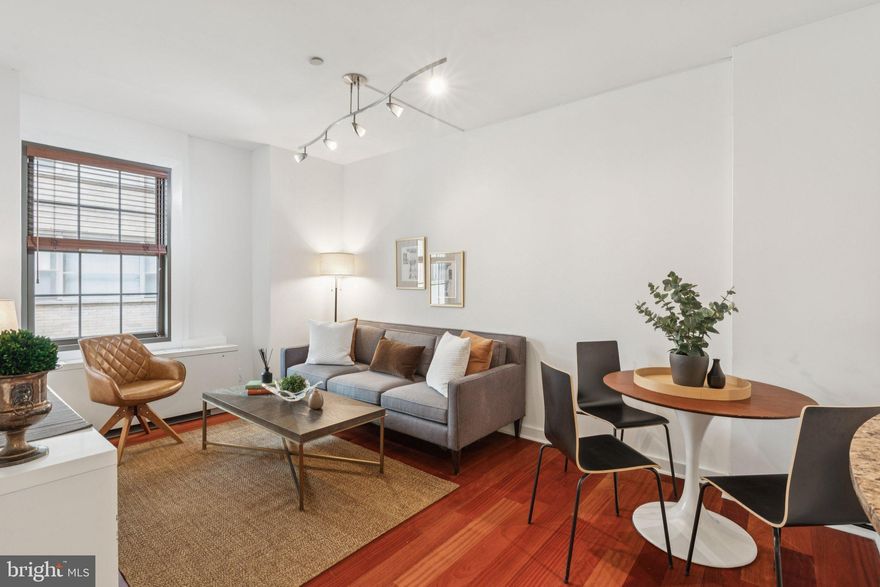 Experience Rittenhouse Square living in this elegant one-bedroom home at Parc Rittenhouse, where classic style meets modern living. Featuring high ceilings, Brazilian Cherry hardwood floors, and a bright, airy layout, the residence offers a welcoming retreat in the heart of the city. The thoughtfully designed galley-style kitchen boasts granite countertops, stainless steel appliances including a new refrigerator, tiled flooring, under-cabinet lighting, and a serving passthrough with a barstool counter that enhances natural light and ease of access into the open-plan living and dining space. The spacious bedroom includes plush carpeting and a large walk-in closet, while the bathroom is beautifully appointed with a Carrera marble vanity, a tub/shower combination, and Kohler ‘Purist’ fixtures. Additional conveniences include a new in-unit dual LG washer/dryer and access to the building's extensive amenities. Parc Rittenhouse offers to its residents 24-hour door staff, a newly renovated fitness center, resident lounge, private theater, conference room, and a rooftop pool club with a sundeck with skyline views. Situated directly on Rittenhouse Square, walk out your door directly to the park, and steps to world-renowned dining  like Parc Restaurant, Via Locusta, Barclay Prime, and La Colombe, and shopping destinations Anthropologie, L'Occitane, Theory and Urban Outfitters. Perfect as a pied-à-terre, starter home, or investment property, this exceptional residence is a great opportunity—schedule your showing today!