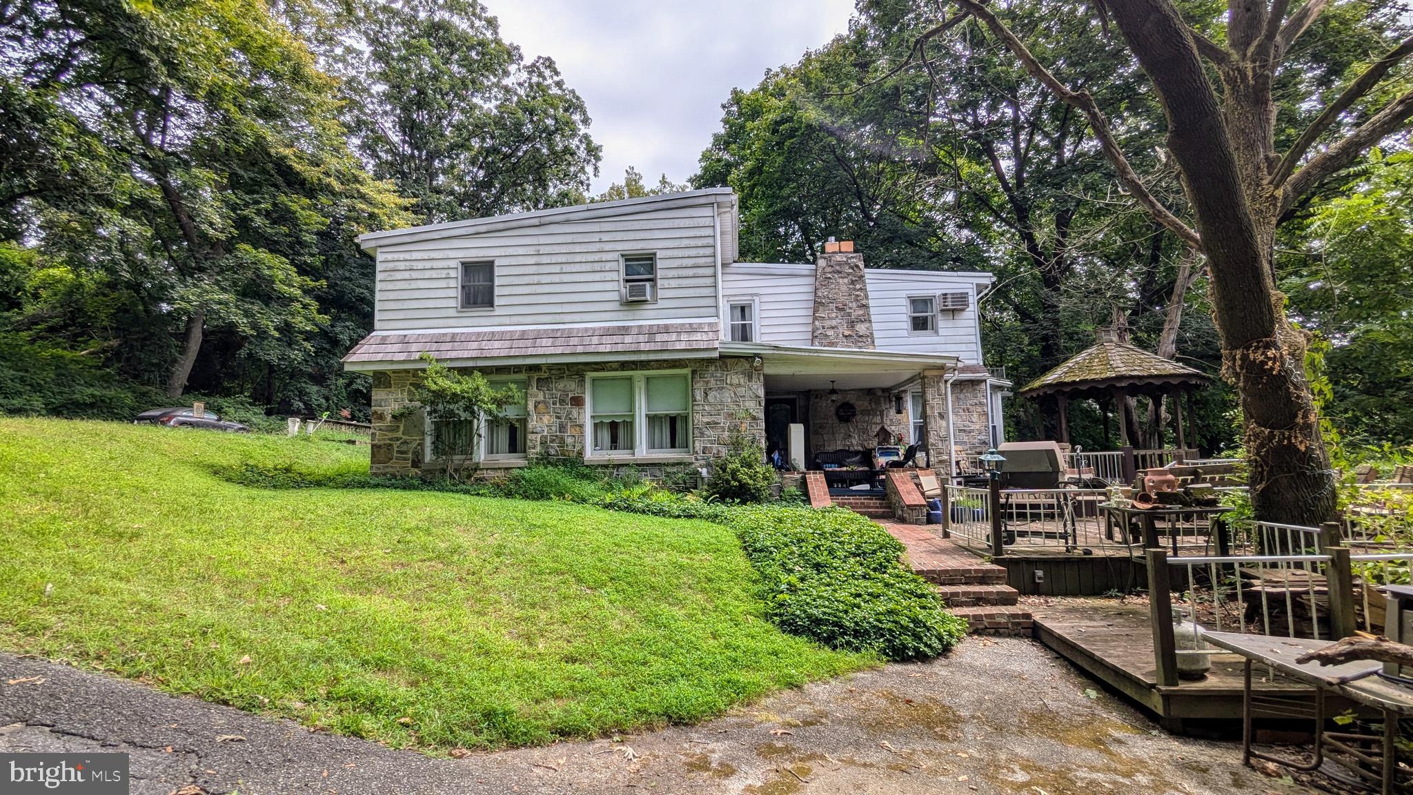 Welcome to a rare opportunity at 1987 Ridgewood Road, a secluded retreat nestled on nearly 7 acres of private, wooded land in York, Pennsylvania. This unique property offers a tranquil, remote feel while being just minutes from all the conveniences of modern living, including easy access to major highways, local attractions, and less than a mile from the excitement of Hollywood Casino.
<<<ABOUT THE HOME>>>
This charming 4-bedroom, 3-full-bath home, spanning over 2,300 square feet, has been lovingly cared for over the years and is ready for its next chapter.
From the moment you step through the solid custom wood front door with its intricate stained glass, you'll feel the character and warmth that defines this home.
<<<FIRST FLOOR>>>
The living room features a heat-producing Heatilator fireplace, and picture windows, perfect for cozy evenings.
Your dining room offers plenty of space and is surrounded with windows for lots of nature views (baby deer pictured), bathing you in natural light.
The office/study provides quiet and comfort, with a fan-forced fireplace, multi pane picture window and custom-made cabinets and shelves.
The heart of the home, the kitchen, is a chef's delight, offering a blend of functional updates and classic charm, carefully created by the current owner. It is equipped with a double oven, electric stove surrounded by brick and a dazzling backsplash, custom, gorgeous granite countertops throughout, and a unique butcher block island, all complemented by an abundance of counter and cabinet space. Custom Tiffany-style stained glass and chandeliers, also found in the china cabinet are throughout the kitchen, add a touch of timeless elegance.
Rounding out the first floor are a convenient guest bedroom with lots of shelves and closet space, and a cute little full bath for convenience and guests.
<<<SECOND FLOOR>>>
Upstairs, the huge master bedroom suite provides a serene escape with his and her bathrooms and its decorative brick-backed fireplace. There is plenty of closets and storage space, two additional bedrooms and a sitting/dressing room to complete the second level.
The home is equipped with a newer Lennox central AC unit to keep you comfortable, and additional built-in AC units on the upper level provide extra cooling on the warmest of days.
<<<ABOUT THE PROPERTY>>>
While the home's interior has been well-maintained and partially updated, the exterior and grounds present a fantastic opportunity for the new owner to customize and restore this property to its full potential. The landscaping, exterior of the home, and outbuildings need some tender loving care to bring them back to their former glory.
Public water and Penn Waste trash service are already in place, and the septic system, with its drain field, is inspected by the township every three years.
This property is a canvas awaiting your vision. Imagine creating your own private oasis while having the vibrant life of York, PA, at your fingertips. From the thriving downtown arts scene and local breweries to the rich historical sites and beautiful parks, York offers a quality of life that is second to none.
Don't miss this chance to own a piece of secluded paradise with all the benefits of a prime York location. Schedule your showing today and discover the endless possibilities that await at 1987 Ridgewood Road.