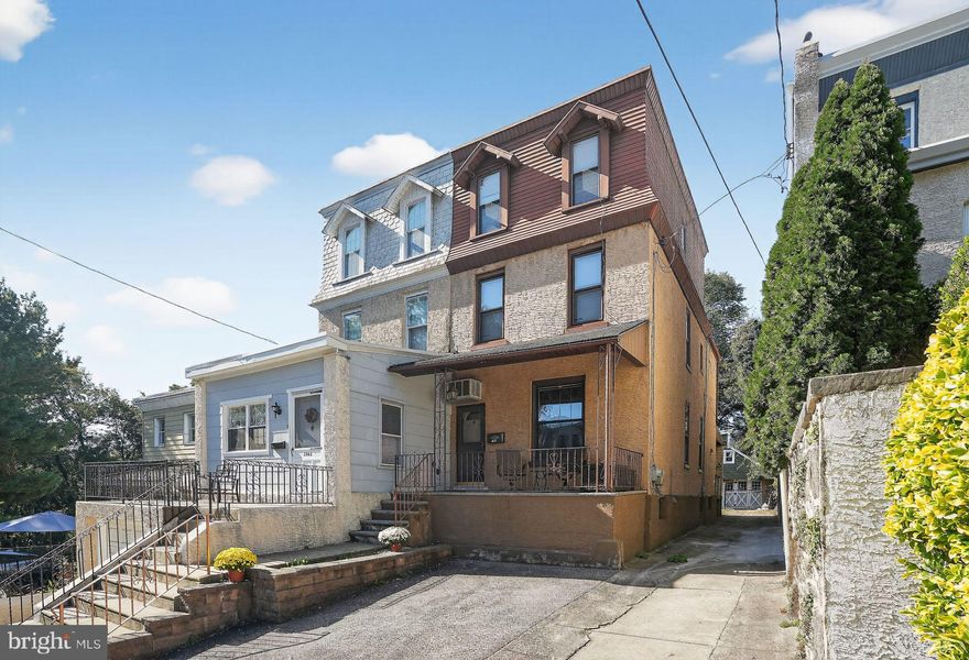 Discover this charming and majestic townhome, perfectly tucked away on a quiet, hidden street just steps from the historic Hundred Steps leading to Forbidden Drive in Fairmount Park. If you love nature, walking, or biking, this home places you right where the best of both city and outdoor living meet.

From the moment you arrive, you’ll appreciate the private driveway and welcoming front porch. Inside, the spacious living and dining rooms feature classic crown molding and beautiful original parquet floors—a rare and timeless touch. The kitchen exudes warmth with its natural wood accents and exposed beams, creating an earthy, inviting atmosphere. Step out the back door to find a second porch showcasing ornate brickwork and a peaceful backyard, perfect for relaxing or entertaining.

Upstairs, the second floor offers two comfortable bedrooms and a hall bath, while the third floor adds two additional bedrooms, providing plenty of space for family, guests, or a home office. The basement includes laundry and utilities for added convenience.

This home is truly a rare find—offering privacy, charm, and walkability to Manayunk’s shops and restaurants, plus easy access to the train and bus stations.
Come experience it before it’s gone!