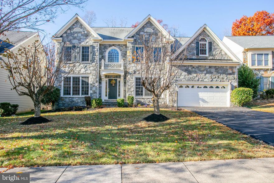 Stunning 4-Level Stone Front Clifton Model by Craftmark Homes! Experience true luxury living in this exquisite residence offering over 6,600 square feet of finished space and 6 spacious bedrooms. Featuring an open floor plan with hardwood floors, brand new carpet, and a Trek-style deck overlooking the 11th tee of Old Hickory Golf Course—this home perfectly blends elegance & comfort. The gourmet kitchen is a chef’s dream, showcasing Monogram GE appliances, a massive island, custom cabinetry, a walk-in pantry, and abundant storage. The adjoining sunroom/morning room with skylights fills the space with natural light, while the family room’s stone-front wood-burning fireplace adds warmth and charm. A main-level office provides the ideal space for working from home. The luxurious primary suite includes a huge walk-in closet, spa-like bath with double shower, and a mini wet bar. The 4th level features a full bath, bedroom, and a second family room—ideal for an au pair or guest suite. The fully finished basement offers a wet bar, theater area, recreation room, 6th bedroom, full bath, and generous storage space. Located in the sought-after River Falls Community—Prince William County’s premier golf course neighborhood—residents enjoy miles of paved trails, pet stations, basketball and tennis courts, and tot lots. Served by top-rated schools including Westridge Elementary, Benton Middle, and Colgan High, and conveniently close to shopping and major commuter routes, this home truly has it all!