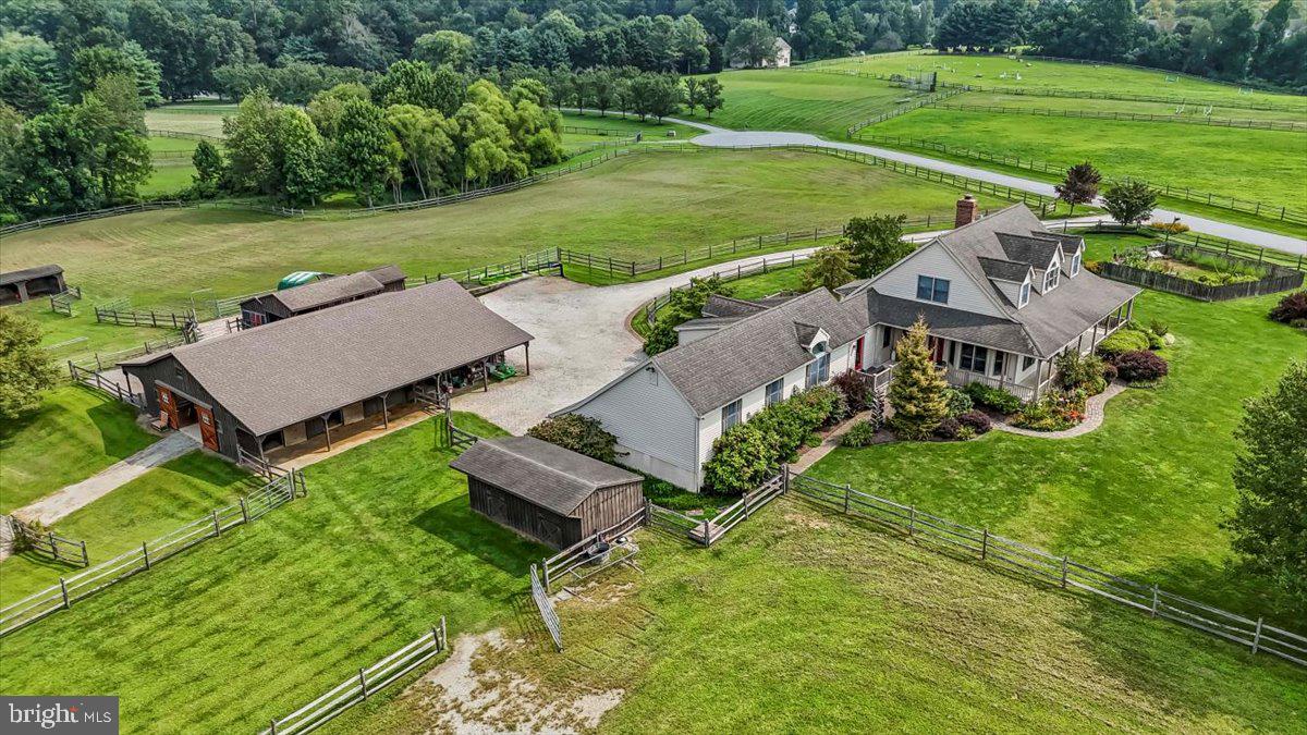 A Rare Equestrian Offering in an Unmatched Location
Rarely does a property come to market that blends thoughtful design, meticulous care, and an equestrian’s dream location. Situated on over 10 picturesque acres directly across from Big Elk Creek State Park and offering direct access to Fair Hill NRMA with over 9,000+ acres of riding, hiking, and biking trails, this facility is a true gem for the horse enthusiast.
The grounds are designed for exceptional pasture management, featuring four large fenced pastures with run-in sheds and three paddocks (two are dry lots). All are enclosed with three-rail split fencing plus electric for added security. The main barn offers six 12’ x 12’ stalls with overhangs and Dutch doors, a heated tack room, powder room, hot and cold wash stall, large feed and hay room, and loft for additional hay storage. Nearby, a shed row holds two additional 12’ x 12’ stalls. The property also boasts a 150' x 90' lighted outdoor arena and two large storage sheds.
The custom-built home by renowned local builder Ivan Umble in sought after Avon Grove School District, offers 3,688 sq. ft. of living space with 3 bedrooms and 2.5 baths. A welcoming wrap-around porch sets the tone, leading to a light-filled interior with site-finished hardwood floors. The first-floor primary suite features two walk in closets and ensuite bath with walk-in shower and deep soaking tub. The living room centers around a wood-burning fireplace, while the gourmet kitchen shines with shaker-style cherry cabinets, granite countertops, KitchenAid appliances, and a breakfast nook. Additional living spaces includes the formal dining room, cathedral ceilinged family room, and the amazing media room, designed and sound proofed by Overture Ultimate Home Electronics.
Modern comforts include a whole-property generator, central vacuum system, and thoughtful craftsmanship throughout. The daylight walk out basement is dry as a bone and ready for you to finish . An added bonus is the attached oversized 3 car garage with openers and storage area. Every element of this farm has been maintained with care, making it as functional as it is beautiful.
This is more than a property—it’s an opportunity to live your dream in one of the most sought-after equestrian locations in the Mid-Atlantic. Schedule your visit today to truly appreciate all it offers.