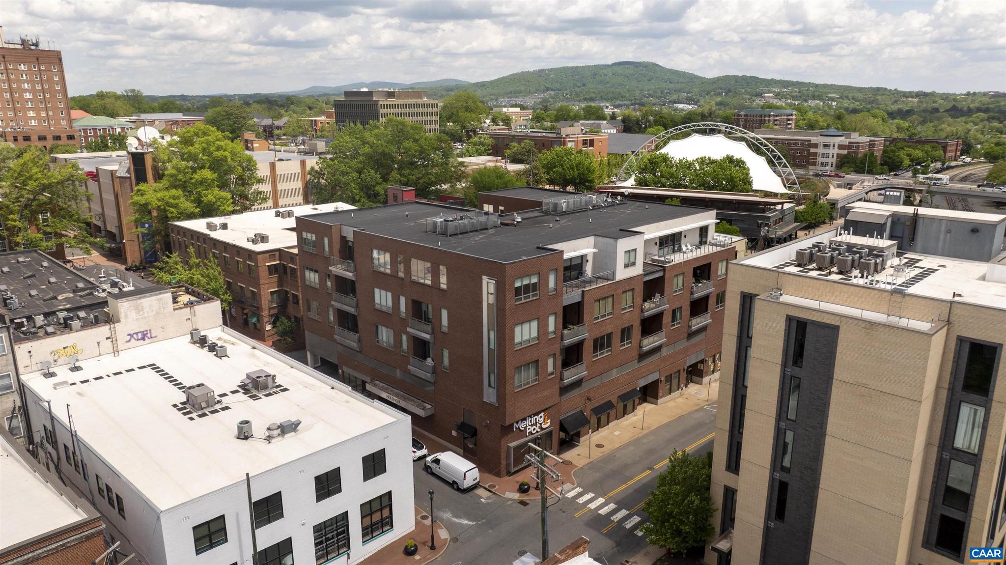 Welcome to this inviting two-bedroom, 2.5-bathroom penthouse corner unit, perfectly located just steps from the Downtown Mall in Charlottesville. This classic, well-maintained residence offers a blend of comfort and style, making it an ideal urban retreat. Situated just half a block from the historic Downtown Mall, you?ll enjoy easy access to a variety of shops, restaurants, and cultural attractions. The penthouse features panoramic views that extend from the vibrant downtown area to the stunning South West mountains, creating an exceptional backdrop for both relaxation and entertaining. With secured parking that includes two designated spaces and convenient elevator service, this property provides ease of living, access and security. The spacious layout, with its impressive 10-foot ceilings and beautiful moldings, and manny built-ins, emphasizes comfort and functionality, making it perfect for everyday living or hosting friends and family. Imagine watching the 4th of July fireworks from your balcony, adding a special touch to your summer celebrations. There are year-around activities to enjoy, plus great shopping and restaurants!!! This penthouse truly offers a unique living experience in a much sought-after location.,Granite Counter,Wood Cabinets