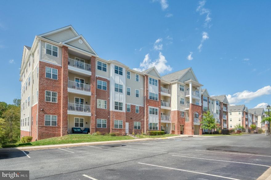 Nestled in the serene Overlook at Gateway community, this ABSOLUTELY Pristine  2nd Floor residence in a multi-elevator building features 2 Bedrooms with bonus Den/Office plus 2.5 baths.  Designed for those seeking a luxurious lifestyle in a vibrant 55+ senior community.  Built in 2020 this elegant "corner unit" unit features plenty of natural light, custom blinds,  and a harmonious blend of modern comforts and timeless design in an open concept floorplan creating an inviting atmosphere for everyday living . The gourmet kitchen boasts upgraded countertops, backsplash, stainless appliances, expansive breakfast bar, spacious pantry, and an eat-in area, perfect for casual dining. The spacious family room, seamlessly connected to the kitchen, is perfect for entertaining family & friends.  Retreat to the primary bedroom suite, featuring a sitting area, new carpet, walk-in closet + bonus closet and private bath with dual vanity & walk-in shower.  2nd Bedroom features ensuite private bath with deluxe luxury WALK-IN jetted tub/shower.  Bonus Den/Office with new carpet gives you additional privacy to work or relax. Enjoy your morning coffee and/ or evening cocktails on the covered porch. Convenient in-unit laundry room and additional storage space in building are a plus!   Amazing community amenities including a welcoming lobby, fitness/ exercise room, community center with kitchen and modern amenities, and much more !  Outside, the beautifully landscaped grounds feature sidewalks and a charming gazebo, and access to the MA/PA Trail - perfect for leisurely strolls. With an attached garage and ample parking, this home offers both comfort and accessibility. Experience the exclusive lifestyle that awaits you in this remarkable community, where luxury meets tranquility and "welcome home" !