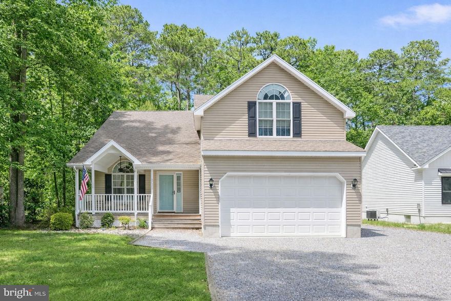 Welcome to this charming coastal-style home located in the sought-after Captain’s Cove Golf & Yacht Club community in Greenbackville, VA. Offering 3 bedrooms, 2.5 baths, and versatile living spaces, this inviting home blends comfort, natural light, and the relaxed lifestyle of Virginia’s Eastern Shore.

A welcoming covered front porch sets the tone as you arrive, creating the perfect place to enjoy morning coffee or unwind in the evening. Inside, the spacious living room features soaring vaulted ceilings and beautiful Palladian windows that fill the home with natural light and create an open, airy feel. A cozy gas fireplace adds warmth and character, making the space ideal for both relaxing and entertaining.

The kitchen and adjoining dining area provide a functional layout with great flow into the main living space, perfect for everyday living and hosting friends and family.

Conveniently located on the main level, the private primary suite offers comfort and ease with its own en-suite bathroom. Upstairs you’ll find a loft overlooking the living room, two generously sized bedrooms, a full bathroom, and a bonus room ideal for a home office, guest space, hobby room, or flex space.

Step outside to the screened-in porch overlooking a peaceful wooded backyard, offering a serene setting for outdoor dining, relaxing, or enjoying nature. Additional highlights include an outdoor shower, perfect after a day on the water or at the beach, and a two-car garage providing plenty of storage.

Located within Captain’s Cove Golf & Yacht Club, residents enjoy an exceptional array of resort-style amenities including:

• 9-hole waterfront golf course
• Indoor & outdoor pools
• Marina with boat launch and boat slips
• Waterfront restaurant & tiki bar
• Fitness center and recreation facilities
• Tennis, basketball & pickleball courts
• Playgrounds, walking paths & community events

Just a short drive to Chincoteague Island and Assateague Island National Seashore, where you can enjoy beaches, boating, fishing, wildlife refuges, and the famous wild ponies.

Whether you're looking for a primary residence, coastal getaway, or investment opportunity, this home offers the perfect opportunity to enjoy resort-style living in Captain’s Cove.