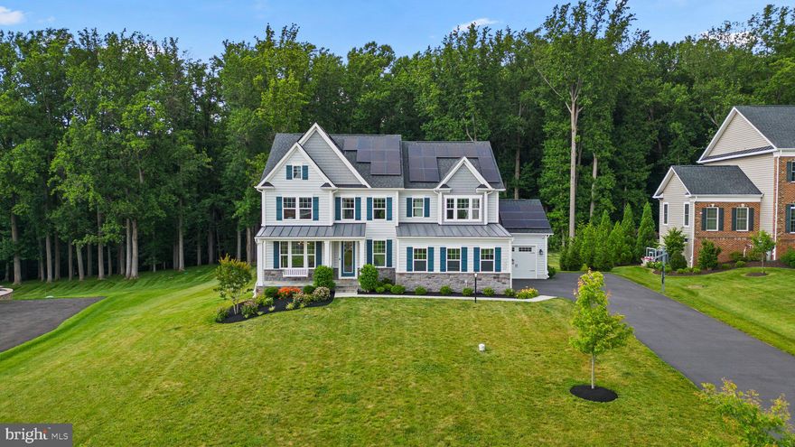 Welcome to 13828 Mill Creek Court - an exquisite colonial residence boasting stunning curb appeal and meticulously designed landscaping. Features include a charming stone pathway, elegant blue shutters, intricate stone detailing, and a picturesque front porch adorned with a swing and awning, framed by verdant shrubbery—ideal for enjoying a serene morning coffee. Step into a breathtaking interior adorned with intricate crown molding, sophisticated light fixtures, and abundant recessed lighting. The space is bathed in ample natural light, accentuating the gleaming hardwood floors and elegant French doors. The main level welcomes you with a bright and open floor plan, beginning with a grand foyer and formal dining room. It seamlessly flows into a cozy family room with a fireplace, a spacious eat-in kitchen with a pantry, a convenient half bathroom, a dedicated office, and a functional mudroom. A chef’s paradise, the immaculate white kitchen showcases top-of-the-line stainless steel appliances, elegant pendant lighting, a chic subway tile backsplash, a high-performance gas range, double ovens, and a spacious island with extra cabinetry for ample storage. Indulge in tranquility and luxury within the expansive owner's suite, graced by a stunning chandelier and pristine hardwood floors. This serene retreat boasts two generous walk-in closets and a spa-like en-suite bathroom, complete with fresh finishes, extended double vanities, a sumptuous soaking tub, and a frameless glass shower featuring a bench and dual shower heads. The upper level also includes a well-appointed laundry room with ample storage, three additional spacious bedrooms, and two full bathrooms, one of which is a Jack and Jill bathroom with dual vanities. The lower level is an entertainer's dream, featuring two expansive recreation areas, a full kitchenette or wet bar complete with an island breakfast bar, a fifth bedroom with an en-suite full bathroom, and convenient walk-out access to a charming stone patio. The expansive backyard boasts a partially covered deck with a cathedral ceiling, skylights, and a ceiling fan, providing a perfect blend of comfort and elegance. Step down to the stone patio and enjoy the vast, open green space that extends to tranquil woods, ensuring added privacy. This sought-after community boasts scenic tree preserves with unmatched access to the everyday amenities of River Hill Village Center, Maple Lawn, and Olney. Enjoy high-end shopping at nearby Columbia Town Center, or take the short half-hour drive to BWI Airport for an easy weekend getaway. Clarksville offers ideal access for both DC and Baltimore commuters. Welcome Home!