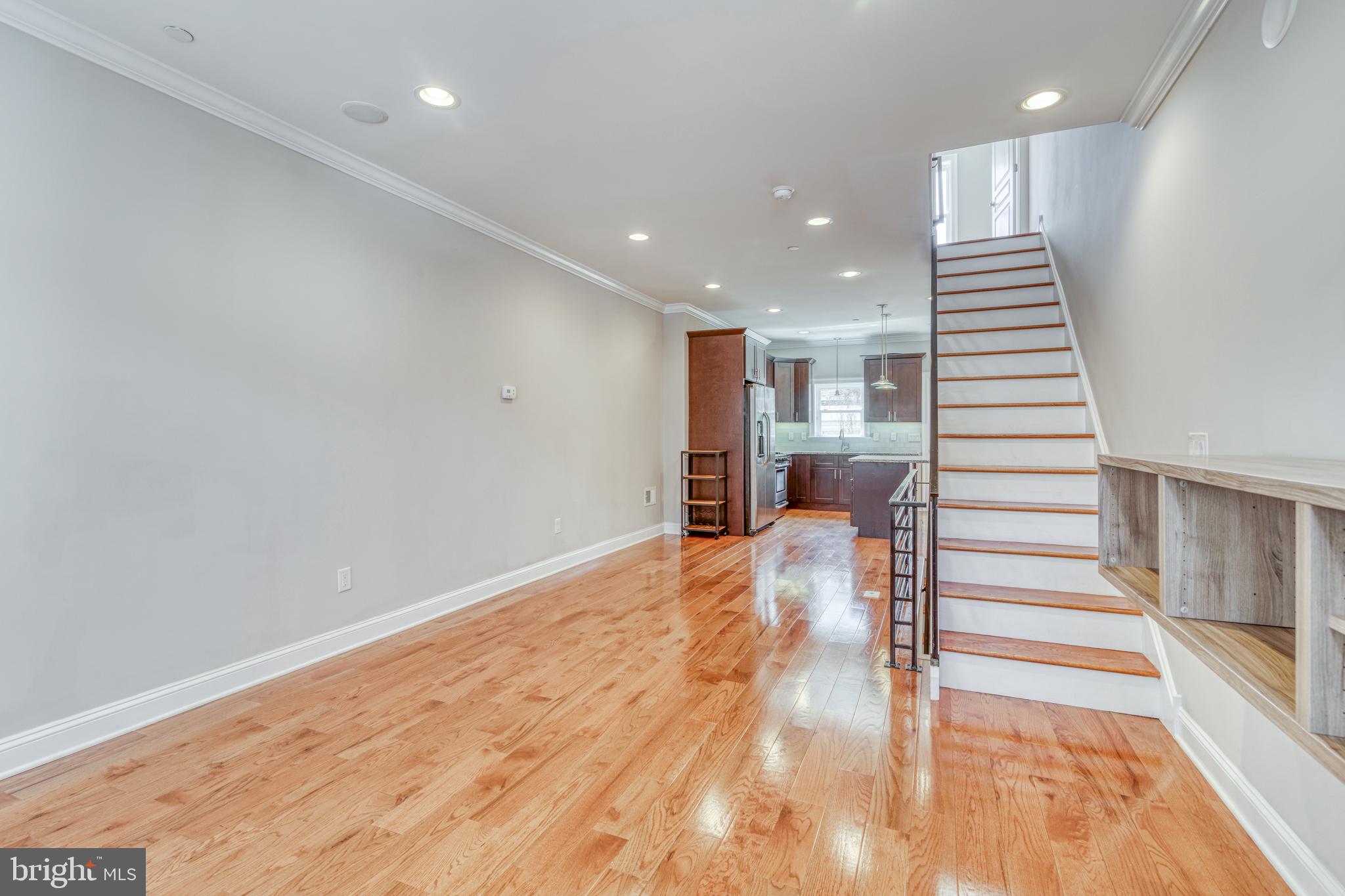 This spacious "Dickinson Narrows" newer construction town home rental is one in a million! At nineteen hundred square feet, this beautiful brick front home features three bedrooms, two and a half designer bathrooms, a large rooftop deck, recessed lighting, central air conditioning, a finished basement and gorgeous hardwood flooring throughout. The open floor concept gives a contemporary feel, while providing plenty of space for customization. On the first floor, you'll find the living/dining areas, as well as the ultra-modern island eat-in kitchen. The kitchen boasts granite counter tops, an immense amount of wood cabinetry, professional grade, stainless steel appliances, all highlighted by a stylish glass back splash. From the kitchen, you'll have convenient access to the rear yard, perfect for summertime cookouts, or just relaxing in the sun! Upstairs you'll find two over-sized bedrooms with an abundance of closet space and a gorgeous tiled hall bathroom. The third floor houses the master suite, fit for Royalty. The master bathroom is complete with a custom over-sized shower, a high end dual sink and vanity, and spa-like details. The lower level has luxe tile flooring, a convenient powder room, tons of storage space, and plenty of room for entertaining guests. The coupe de grace is the large roof deck, which has lighting and is fully wired for audio with multiple speakers! There is also a security system and intercom! This amazing home also boasts plenty of street parking with no time limit! Don't miss the opportunity to make this home yours! Virtual Matterport tour: https://my.matterport.com/show/?m=y7ahvzYWnHn
