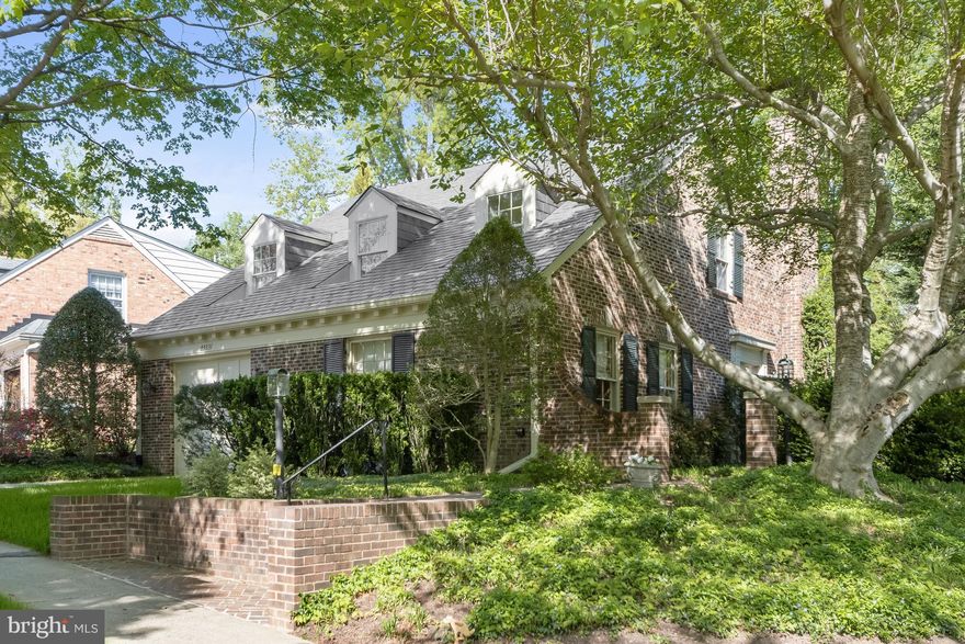NEW LISTING IN OVERLOOK - WESTMORELAND HILLS, JUST OVER THE DC BORDER! WELCOME TO 4423 BOXWOOD ROAD with water views and a first-floor bedroom (currently used as a library). Set among tree-lined streets, 4423 Boxwood Road is a charming 4 bedroom, 4 full-bath retreat in the heart of the Overlook community with 4306 sq ft of interior space on 3 levels. The home overlooks an expansive open green space maintained by the HOA. The private side-garden entrance opens to a welcoming foyer which leads to the living room with a wood-burning fireplace and French doors leading to the extensive terrace with boxwood, climbing quince, hydrangea and large dogwood trees. The living room flows into an open concept dining room complete with a wet bar, making it an ideal space for entertaining. Next to the dining room is the gourmet eat-in kitchen/family room with a large island, fireplace, built-in cabinetry, a washer and dryer, and water views. This large, light-filled addition also enjoys patio access, creating seamless indoor/outdoor living, a rare find so close to the city! A first-floor bedroom or library complete with custom built-ins offers flexible space for main level living and is adjacent to a full bath and large closet. A single garage with interior entry adds everyday convenience to the main level. Upstairs, a sun-filled primary bedroom with a large ensuite full bath features 3 dormer windows and two large closets. The additional two bedrooms are connected by a full bath. The lower-level features 8-foot ceilings, a spacious living space anchored by a wall of cabinetry, a full bath, a large storage/utility room and an additional closet. With its generous patio, water views, and private setting, this approximately 4,306 SF home represents the “best in class” in this desirable neighborhood with easy access to city living. Overlook is a friendly neighborhood with the conveniences of an active HOA, a private pool, and tree-lined sidewalks for leisurely walks through the quiet streets. Parks and trails are minutes away! The neighborhood is in close proximity to Spring Valley and Westbard Square shops and restaurants, Friendship Heights Metro, the Massachusetts Ave bus line, the Capital Crescent Trail, parks, downtown DC and Bethesda. Westbrook / Westland / BCC schools serve this elegant neighborhood. Showings by appointment only.