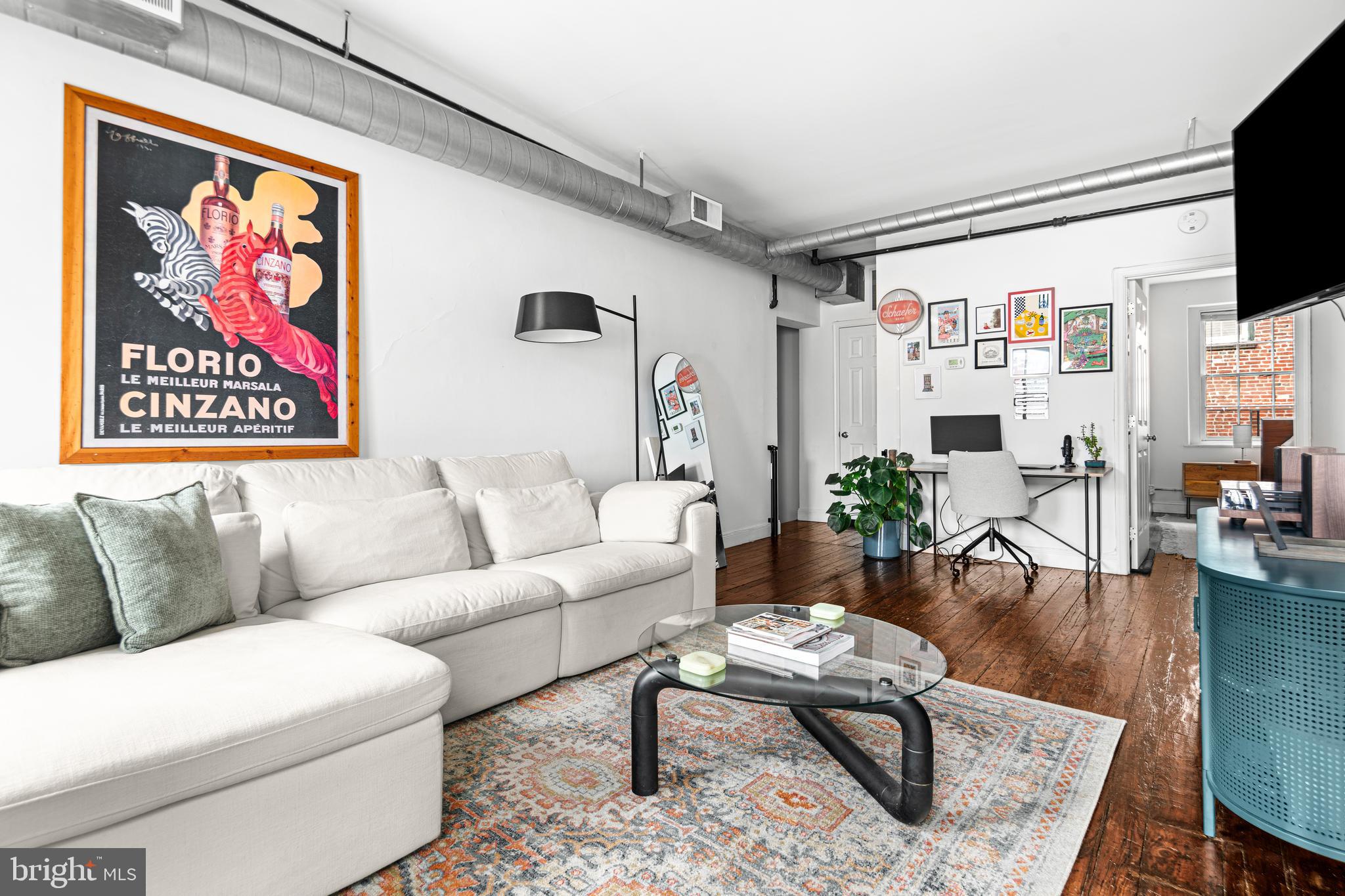 Loft-style condo centrally located in the heart of Old City. Old world style with modern updates throughout! Original wide-plank pine floors, warehouse-style windows and high ceilings. Large entry foyer provides ample space away from the living area for shoes, coats and bags. Spacious open floorplan with room for dining and living areas and an open kitchen with black cabinets, a mix of black and stainless steel appliances, and a butcher block island. Spacious bedroom has a walk-in closet and a large en suite bath with black-and-white checkerboard tile floor, tub with ceramic tile surround and oversize Waterpik showerhead, and a clean white storage vanity. In unit stackable washer/dryer off the kitchen completes the package. Surrounded by Old City amenities, restaurants, cafes, coffeeshop, boutique shops, and fine dining are just foosteps from your door! With a 99 walk score, this is a walker's paradise!