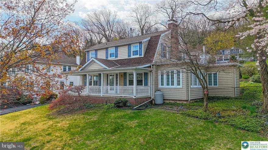 Near the edge of town on a lovely tree-lined street you find this marvelous home. An expansive, covered front porch is the perfect welcome, brick inlay adding charm to the durable concrete. Gleaming original hardwoods lead to a lovely staircase, the landing window adding brilliant light to the space. To the right a sprawling family room with central fireplace opens via French doors to the four-season sunroom with private full bath beyond. Across the home is the formal dining and updated kitchen mixing original charm with welcome modern convenience. Completing this level is a morning room, situated as they are to take in the vista of the home’s backyard with its terraced gardens. Upstairs, a large primary bedroom is complimented by two lovely additional beds, all with multi-directional windows capturing light. Another updated bath with jetted tub completes this level. The first and second floors offer beautifully maintained hardwoods as well as original doors and their hardware, exquisite detail. The basement offers an expansive room housing utilities and abundant storage potential, with the remaining portion is finished into a comfortable family room with wet bar and third updated full bath! To the rear, a concrete patio sits beneath a gorgeous, terraced yard with lovely rhododendron, boxwood, and more! A side driveway offers abundant off-street parking. The original charm is met with welcome updates in Central AC and Vacuum, as well as replacement windows! Not to be missed!