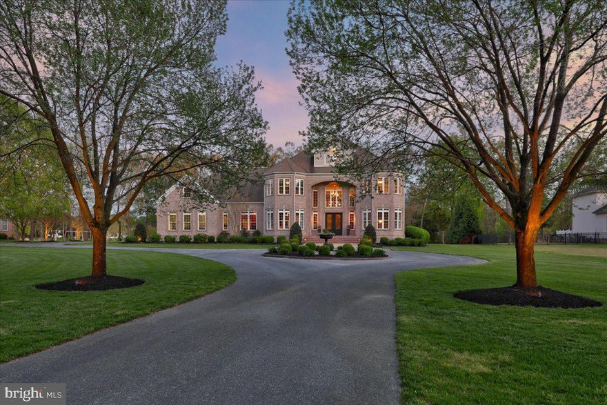 Once in a lifetime opportunity to purchase this residence located on a quiet impasse street. This palatial residence, perfect for multi-generational living, maintains seven bedrooms, seven full baths and one half bathroom across nearly 8,000 square feet. Situated on nearly four acres of lush river front property with immaculately landscaped yard, professionally designed flower beds and thoughtful landscape lighting. Upon arriving at 1404 Bell Island Trail you are warmly welcomed into the stately drive of this brick home. Walking up the front steps of this resplendent home and just through the front doors you will surely be awe-struck at the sheer scale of this residence. The warm wood tones throughout welcome you into the grand two-story foyer with allows access to the dining room, flexible formal living space (currently set up as a game room with a pool table) and perhaps one of the most prominent thoroughfares is through to the living room with floor to ceiling windows allowing views of the rear yard and river. Just off the generously sized phosphorescent living room you will find the freshly installed bar with warm navy blue cabinetry and gold accents outfitted with a large wine fridge, ice maker and of course a wet bar sink. Just through the bar space you will find the well furnished kitchen with viking appliances, granite surfaces and a lovely morning room with 180 degree views of your lush yard and river. This side of the home allows access to a large pantry, laundry room, full bath and a bedroom currently configured as an office with brilliant warm wood paneling. Access to the oversized three car garage with several storage closets is also maintained in this wing of the home. Just on the other side of the home you will find a bedroom suite allowing access to the rear yard via french doors and a private porch space. This bedroom suite is complete with its own walk-in closet and full bathroom. Access to the second floor is granted by using the grand front staircase, side staircase or the elevator which services all three floors of this home. Upon arriving on the second floor you will note two bedrooms, one with an ensuite bath maintained on the right side of the home while on the opposite side there are two bedrooms with ensuite baths, a second laundry room, and flexible room perfect for an additional bedroom, nanny space or home theater as it is outfitted with a wet bar and refrigerator. There is a staircase at the midpoint on this floor, next to the elevator which allows access to the third floor solely reserved for the primary suite. It is true - dreams and the actual definition of “primary suite” were modeled after this exact space! You are welcomed by your own private wet bar just outside of the primary, perfect for coffee or drinks! The double entry doors open to reveal an opulent bedroom with vaulted tray ceilings, large dual closets and of course the generously sized bathroom with dual vanities, fully tiled shower and soaking tub. The exterior of this home is perhaps as spectacular as its interior. The lush lot totalling almost four acres of property affords some of the most breathtaking views of the Wicomico River while maintaining privacy due to the property's geography. The entertainment space just off the morning room on the first floor provides access to several entertaining spaces of which include a gas fire pit area, dining and entertaining space and a second wood fire space with tranquil water feature. At dusk this residence truly stands out with its smartly positioned landscape lighting which sets the mood for wonderful evenings with friends and family to enjoy this palatial residence. The current home owners have completed the heavy lifting to obtain a pool permit and have submitted a pier permit which will convey to the new owners. Matterport tour, floor plans, and additional photos in addition to pool info and elevation as well as dock layouts available upon request.