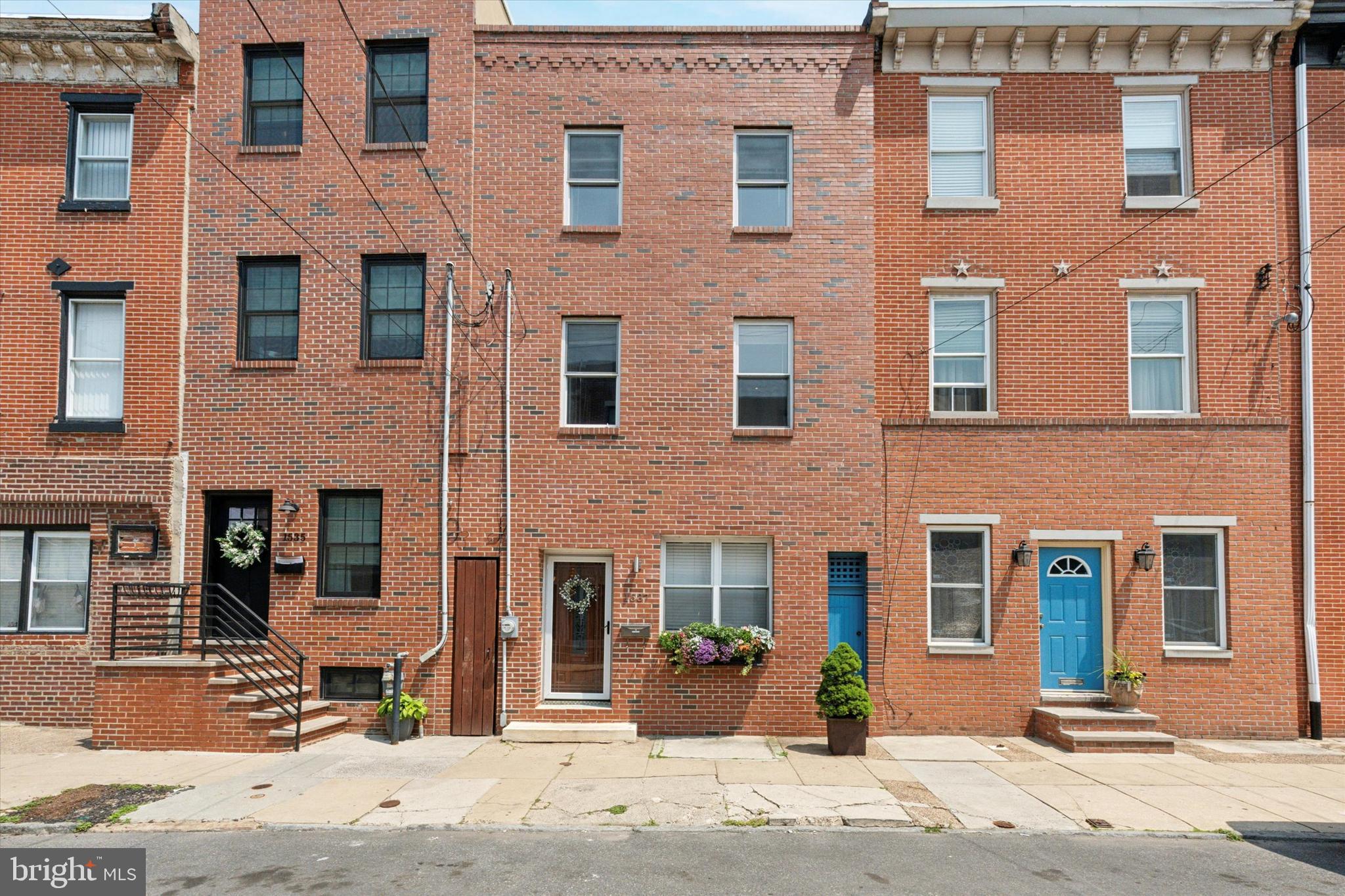 Terrific on Two Street! Whether you love the Mummers or not, this home stands out on its own! Welcome to 1537 s. 2nd Street, a perfectly move-in ready home in the heart of Pennsport! This concession free, fully renovated three story home has it all including three bedrooms, two and a half bathrooms, a finished basement and an amazing rear yard at almost 1,700 sq ft of living space! The beautiful brick facade sets the tone. As you enter, you can't miss the wide plank hardwood floors along with tons of upgraded millwork throughout the home. The open first floor plan is perfection and includes a large living space, full dining room and kitchen in the rear just off the side door leading out to the yard. The kitchen is complete with large shaker style cabinetry, stainless steel appliances, quartz countertops and tile backsplash. Head out from there to the enormous yard, perfect for all types of entertainment and relaxation! The second floor has two spacious bedrooms, each with great lighting and closet space, split by a hall bath with a full tile surround and bench tub. Head up to the third floor primary suite, where you will find a spacious bedroom, great closet space, and a newly renovated bathroom which includes a double vanity, free standing soaking tub, and beautiful shower with rain head and hand held! Finally, head down to the finished basement with powder room for that extra bit of recreational space that is always useful! Take note of the carpentry upgrades throughout including: single panel doors, crown molding and wainscoting throughout the first floor, wainscoting in hallway throughout, deep sills, and upgraded trim! The location speaks for itself - stand on your front step on New Year's Day for a front row seat of the Mummer's Parade! On any other day, you can walk within minutes to all Pennsport has to offer, Passyunk Square, Queen Village, all big box retail on Columbus Blvd right around the corner! Get to the sports complex within minutes to catch a game. Hop right on 95 to get in and out of the city or over the bridge. Take a look at this home and enjoy living the dream!