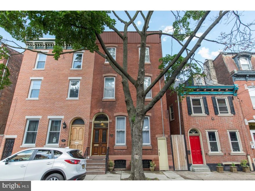 Amazing opportunity to own this impeccably maintained, one-of-a-kind Victorian mini-mansion located in the highly sought after riverside section of historic Fishtown. Built in the late 1800s, this grand Philadelphia home is 3,100 square feet of charm & history. It has been lovingly restored, keeping all of the original character, including: beautiful double front doors with etched glass, marble entry with stained glass double doors, 10 ft dark wood parlor doors, French doors leading into the dining room, original hardwood floors throughout -- with hardwood inlays on the first floor and gorgeous random-width red pine on the upper floors -- original hardware and glass door knobs, original restored and rewired light fixtures throughout. This home boasts 6 airy and light-filled bedrooms, 1 and a half baths, a new custom kitchen with stainless steel appliances, new high efficiency heating system, new 200 amp electricity with period push button switches retained for character. The full bath includes original tile and cast iron/porcelain soaking tub. The master bedroom features a wintertime view of the center city skyline and a custom closet, made with mirrored doors salvaged from an old neighborhood barber shop. The impressive original crown molding highlights the extra spacious 11 ft ceilings. Second floor laundry room for added convenience, updated with new washer and dryer. The private backyard is the perfect sanctuary/garden oasis with plenty of room for gatherings. New roof installed in 2011. Very large basement, with ample ceiling height, that can be finished or used for storage. Situated on one of the best and most beautiful tree-lined blocks in Fishtown, you'll be within walking distance to Penn Treaty park, public transportation, and all of the neighborhood shops and attractions such as Johnny Brenda's, The Fillmore, Frankford Hall, Stock, Wm. Mulherin's Sons, and so much more. We welcome you to visit this absolute stunner today!