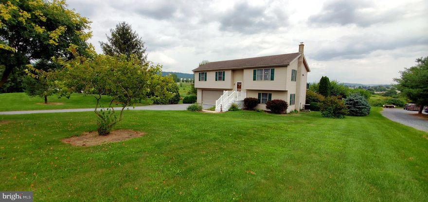 Imagine enjoying peaceful evenings at this beautiful property with endless views of the Blue Mountains. This 3 bedroom 1.5  bath home sits on an expansive 1.38 acre lot. Possibilities abound in this perfect setting. The kitchen, dining area and living room flow together in a welcoming manner. The bedrooms are all generous sizes with ample closet space. The primary bedroom features a half bath as well as a window that overlooks the large back yard. Downstairs you will find an inviting family room which features a woodstove which could be used to heat the entire home. The lower level also provides inside access to the large 2 car garage and the laundry and utility area. The deck, which can be accessed from the backyard or the kitchen, provides additional entertaining area and is a nice perch to keep an eye on the backyard. The lawn has flowers and mature plants including an apple tree. There is ample room for activities, entertaining or gardening. This property has provided a wonderful home in which to live for the current owners. They are excited to see a new owner add their own special touch to make it their own. Be sure to schedule your private tour of this home soon.