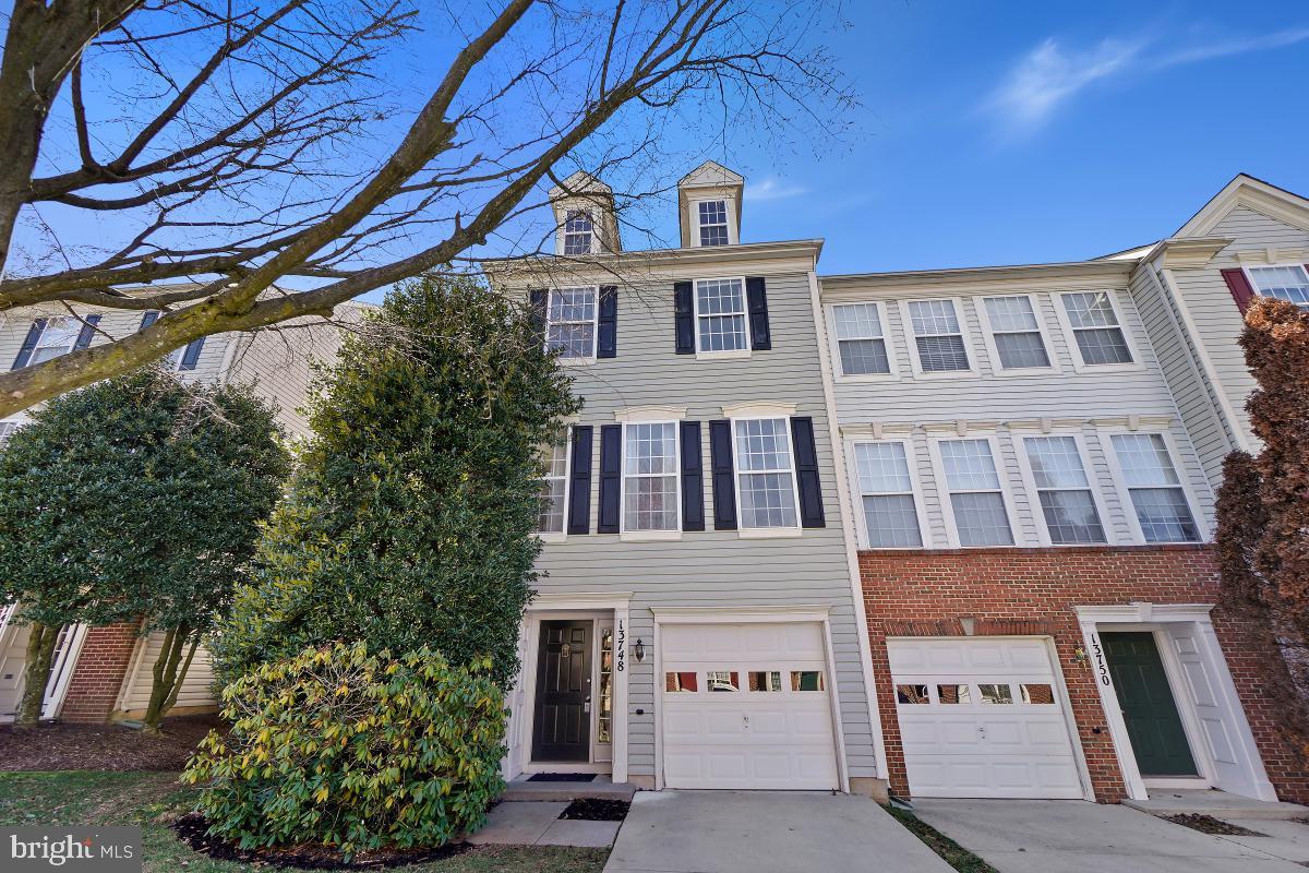 Welcome to 13748 Dunbar Terrace in the desirable Kingsview Village community! This spacious end-unit townhome offers over 2,200 square feet of living space across 3 finished levels. As you enter the home, you are greeted with a lower-level entry featuring garage access and a large family room boasting a cozy gas fireplace and built-in shelving. This level also includes a convenient dedicated laundry area. The open concept main level showcases gleaming wood flooring throughout, creating a warm and inviting atmosphere. The living room is bathed in natural light from numerous windows, while the dining room features beautiful wainscoting trim detail. The gourmet eat-in kitchen has an island featuring breakfast bar seating, ample cabinetry, and direct access to the large back deck. The deck overlooks the lush treelined conservation area, providing the perfect backdrop for outdoor entertaining and enjoyment. Upstairs, the bedroom level boasts a primary suite with a vaulted ceiling, walk-in closet, and an ensuite bath upgraded with a soaking tub, double sink vanity, and a walk-in glass and tile shower. The secondary bedrooms share a full bath, providing comfort and convenience for family and guests. Enjoy the convenience of new carpet throughout the home. The Kingsview Village community offers a range of amenities including a swimming pool, walking paths, and playground ensuring a vibrant and active lifestyle for residents. Located just minutes from shopping, restaurants, local parks, and schools. Easy access to major transportation routes including I-270, 355, and public transit options. Marc Train station less than 1 mile away!
