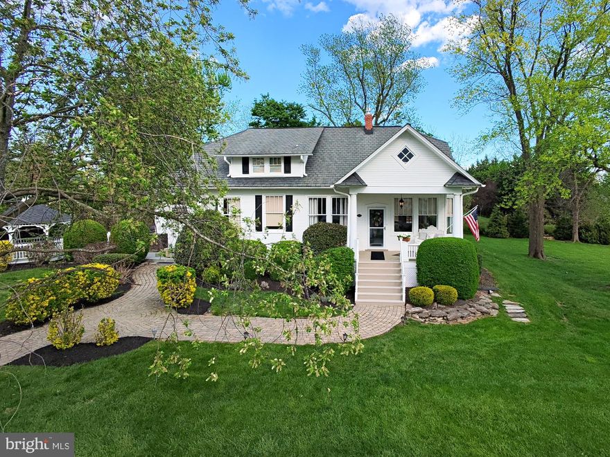 The wait is over—this 1930s masterpiece is BACK on the market and in bloom for Spring after a quiet Winter hiatus. If you missed your chance last year, now is the time. This home perfectly balances classic elegance and refinement with 21st-century luxury and proximity to town. Nestled in sought-after Ijamsville, between historic New Market and the popular Oakdale area, this estate offers a rare blend of old-world charm and 2020s convenience. The reimagined kitchen is a showstopper, blending high-end functionality with soulful history in the true heart of this home. Custom-glazed vanilla cabinets featuring soft-close drawers and built-ins like spice racks hit the mark, while the crystal-accented pulls shine under vaulted ceilings with wood-adorned beams plus views of the curated landscape outside. The one-of-a-kind antique wood entertaining island repurposed from a historic store display is a true centerpiece, perfect for displaying buffet or hostess items, or simply giving ample counter space to plan and execute culinary masterpieces. The upgraded appliances spare no exception to the luxury, featuring a six-burner gas range, convenient pot filler, and French door refrigerator. A cozy upholstered breakfast nook gives daily glamour to casual coffee mornings, and a formal dining room defined by iconic columns and a sparkling chandelier provide a more formal entertaining space for guests and special meals. Every inch of this residence oozes with historic soul, having been meticulously maintained to preserve the architectural DNA, while integrating modern essentials and creature comforts like central AC, dual water heaters (for the two soaking tubs), a luxurious Owner's suite, and an easy to operate fireplace insert giving warmth and ambiance at the click of a button. Authentic details envelop you in charm, including 10' ceilings in the main living spaces, period moulding, original character hardwoods, original and curated replica chandeliers, solid brass hardware, intricate original glasswork, and the traditional fireplace surround/mantle--just for starters. Multiple "flex" rooms can be tasked to deftly serve as full-time bedrooms, home offices, or hobby spaces—including a main-level artist’s workshop with private back patio access that flanks a convenient full bathroom, which could be easily utilized as a main level bed/bath space. The reimagined upper level is mostly dedicated to a sprawling primary suite entered through stained-glass double doors. It features a marble-clad ensuite bath with a jetted corner tub and separate shower with seat, a quaint vanity nook, and an upholstered window seat. Here you will find incredible storage options, with nearly a dozen closets and built-ins sprinkled throughout the space, plus a private laundry room with even more storage area. Lose yourself in the outdoor dreamscape, designed for those who love to entertain or just spend solitary times close to home in style. Directly off of the kitchen space you will find a spacious cocktail patio with stone-front serving bar and whimsical gazebo, and to the other side of the grounds sits a custom pavilion anchored by a cozy wood-burning natural stone fireplace. A charming semi-finished accessory cottage adorned with storybook flower boxes makes for a perfect for a studio or even guest overflow in a pinch, and an additional storage shed keeps all of your landscape tools stored out of sight. The curated grounds come alive each spring with annual plantings, mature hedges and landscape beds, majestic hardwood and evergreen trees, and a separate hobby garden area, all with views easily enjoyed rain or shine on one of the two classic covered porches. A traditional long paved drive adds drama and an estate feel to the approach of the home, terminating at the detached two-car garage with opener and separate rear door access, providing plenty of privacy from the road. Minutes from Lake Linganore Town Center, Downtown Frederick, and historic New Market.