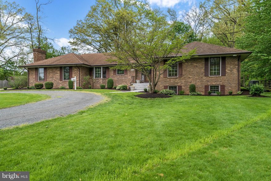 Spacious all-brick custom rambler on private 1.5-acre lot in Hamilton.  Quality construction, main-level living, 2-car side-load garage, gleaming hardwood floors, country kitchen with tile and stainless appliances, family room with fireplace off kitchen and breakfast area.  Formal living room & dining room w/sliders to patio; 3 BR, 3 full baths up, LL Rec Rm, 2 bonus rooms and full bath.  No HOA.