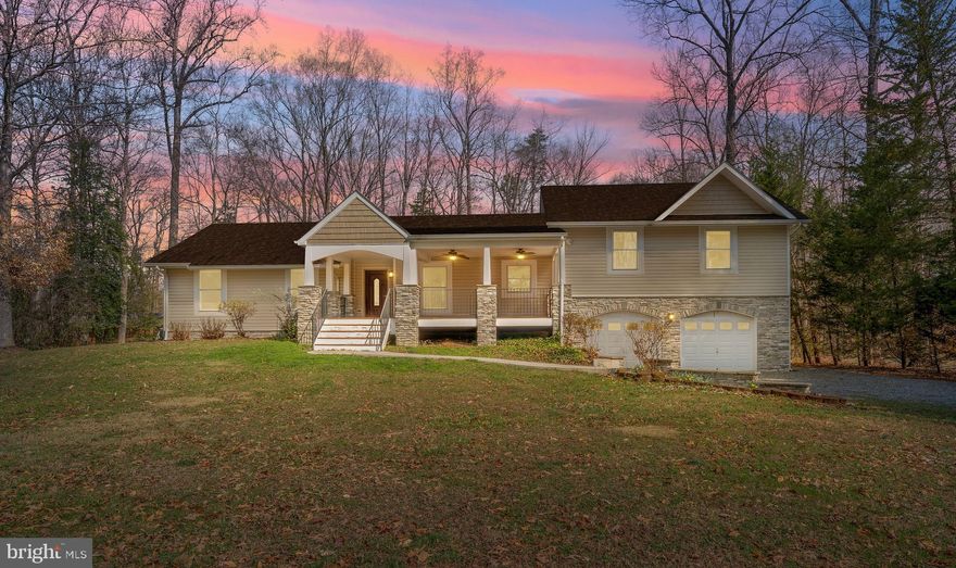 Nestled along the tranquil shores of Lake Anna, this beautifully maintained waterfront retreat offers the perfect blend of comfort, recreation, and scenic lake living. Situated on the highly desirable private side of the lake, the property boasts over 300 feet of shoreline along Pool 3, creating an exceptional setting for boating, swimming, fishing, and unforgettable sunsets. The home sits on 1.89 acres of wooded, park-like land, providing privacy, room to explore, and a scenic walk to the waterfront.

Inside, the home features 3 bedrooms and 2 full baths with an inviting open-concept layout designed for both everyday living and entertaining. The main living spaces and kitchen were thoughtfully updated in 2016 with new cabinetry, appliances, flooring, and bath fixtures. The spacious kitchen showcases granite countertops, abundant cabinetry, and generous prep space, seamlessly connecting to the dining and living areas. Hardwood flooring runs throughout the main living areas and bedrooms, while tile accents the bathrooms. A wood-burning fireplace anchors the living room, creating a warm gathering space during cooler months.

The oversized two-car garage is exceptionally spacious, providing plenty of room for vehicles, lake gear, tools, and additional storage.

Above the garage, a large bonus room offers incredible flexibility—perfect for a game room, media room, or a guest retreat. The partially finished walk-out basement provides immediate usable space with potential for additional expansion.

Outdoor living is where this home truly shines. A charming covered front porch overlooks the front yard, while the expansive rear deck offers peaceful wooded views, creating a quiet setting for morning coffee or evening relaxation. From the backyard, a gentle walkway leads through the park-like landscape to the waterfront, where you’ll find a private boat slip, storage shed, and a sun deck built in 2020. A large flat grassy area near the shoreline provides the perfect spot for lawn games, gatherings, and enjoying long summer days by the water.

Located in the heart of the Lake Anna region, the home offers the perfect balance of peaceful waterfront living with convenient access to nearby amenities. Shopping, dining, and marinas are just a short drive away, while outdoor recreation can be enjoyed at nearby Lake Anna State Park. The property is approximately 45–50 minutes from Fredericksburg, about an hour from Richmond, and within reach of the Washington metro area, making it ideal as a full-time residence, weekend getaway, or investment opportunity.

Whether you’re hosting friends on the deck, enjoying quiet mornings on the water, or spending the day boating and fishing, this exceptional lakefront property offers the lifestyle many dream about.

The home is also offered for rent.

Experience the relaxed lifestyle and natural beauty that make Lake Anna one of Virginia’s most beloved waterfront destinations.