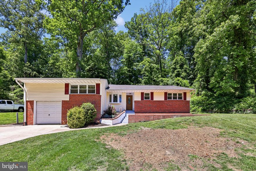 Are you searching for the perfect home with comfortable main-level living and room to grow? This well-maintained 4-bedroom, 2 full bath split-level home offers the ideal blend of space, function, and natural surroundings, all set on an expansive .43-acre lot backing to trees for added privacy.
Step inside to find a bright and open living and dining area featuring hardwood flooring throughout the main level, creating a warm and inviting atmosphere. The eat-in kitchen is filled with natural light from large windows and showcases upgraded quartz countertops, offering both style and functionality for everyday living and entertaining.
The home features a spacious primary bedroom, along with three additional bedrooms providing flexibility for guests, home office space, or multi-generational living. Enjoy cozy evenings by the wood-burning fireplace, and take advantage of the seamless indoor-outdoor flow to the concrete patio, perfect for relaxing, entertaining, or creating your own garden oasis.
Additional highlights include a 1-car attached garage, generous driveway parking, and a thoughtfully designed split-level layout that maximizes living space.
Located in the desirable Triangle/Dumfries area of Prince William County, this home offers unmatched convenience and access to:
Quantico Marine Base, Potomac Mills Mall, Stonebridge at Potomac Town Center, and local shopping & dining, Sentara Northern Virginia Medical Center, Prince William Forest Park, Locust Shade Park, and nearby trails, Museums, parks, and outdoor recreation
Commuters will appreciate easy access to I-95, Route 1, commuter lots, and the VRE, making travel to Northern Virginia, Washington, DC, and surrounding areas seamless.
With no HOA, natural surroundings, and a prime location close to everything, this home presents a rare opportunity to enjoy space, convenience, and value. Schedule your tour today and experience all this property has to offer.