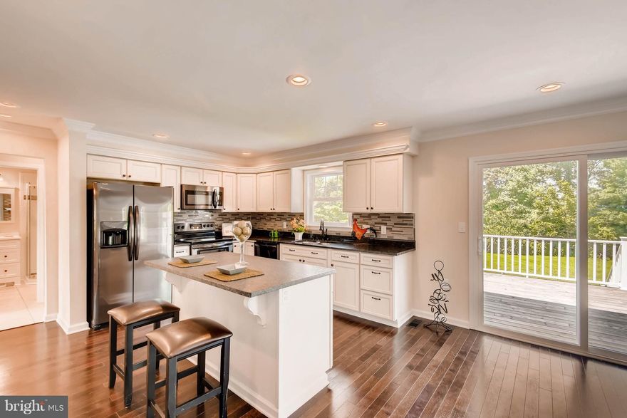 Town and country living on a private cul-de-sac. Drink your favorite beverage rocking on your front porch or entertain the whole family on the large rear deck with expansive views of landscape and mature woods.  Six bedrooms and four bathrooms to raise your family and make memories to last a life time on this completely remodeled center-hall colonial.