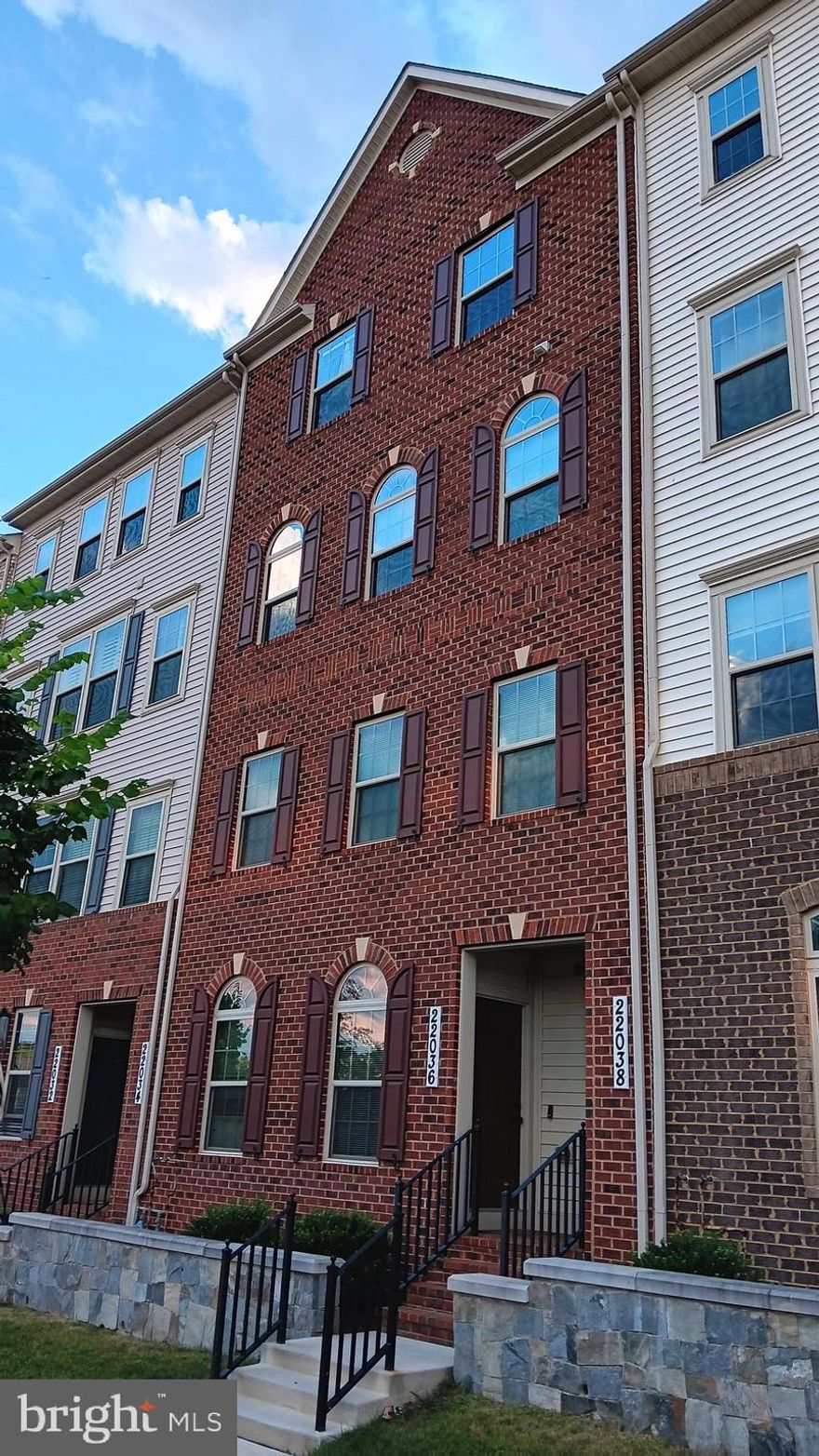 SELLER WILL ASSIST WITH YOUR CLOSING COSTS - $10,000! Paint your own picture inside of this 3rd & 4th level condo style 'Picasso' (floor plan attached).  The beautiful brick exterior is just the beginning of what the interior boasts! Rear garage entry allows for easy access to the interior entryway.  The start of the living space features a well-placed powder room w/large window, so your Guests won't be left sitting in the dark!

Perfectly placed windows allow for natural, bright light to flow throughout the Living, Dining and Family room spaces.  Stunning, gourmet kitchen boasts beautiful quartz countertops, ample cabinetry including 42", generous sized island featuring large sink w/oversized detachable faucet and pendant lighting. Stainless steel appliance package contains side by side refrigerator/freezer w/water dispenser, gas range/stove, dishwasher and built-in microwave. Pantry offers additional storage.

Primary bedroom - "Look up!" Tray ceiling with crown molding is the centerpiece that commands attention in this space. Two walk-in closets w/shelving systems and a sitting area creates a lounging space. Primary en suite features two separate sinks w/quartz countertops and under counter cabinetry. Glass doored shower w/bench seating, detachable rain head, window and recessed light. A convenient water closet and linen closet finish out the space.

Rounding out the bedroom level is the 2nd bedroom w/walk-in closet, 3rd bedroom, hallway bath featuring double quartz countertop sinks and tub shower. Easy access to laundry room with cabinet system, countertops and front-loading washer/dryer set.

Don't forget! ...enjoy outdoor space or extend your entertainment onto the covered exterior deck just off of the kitchen.