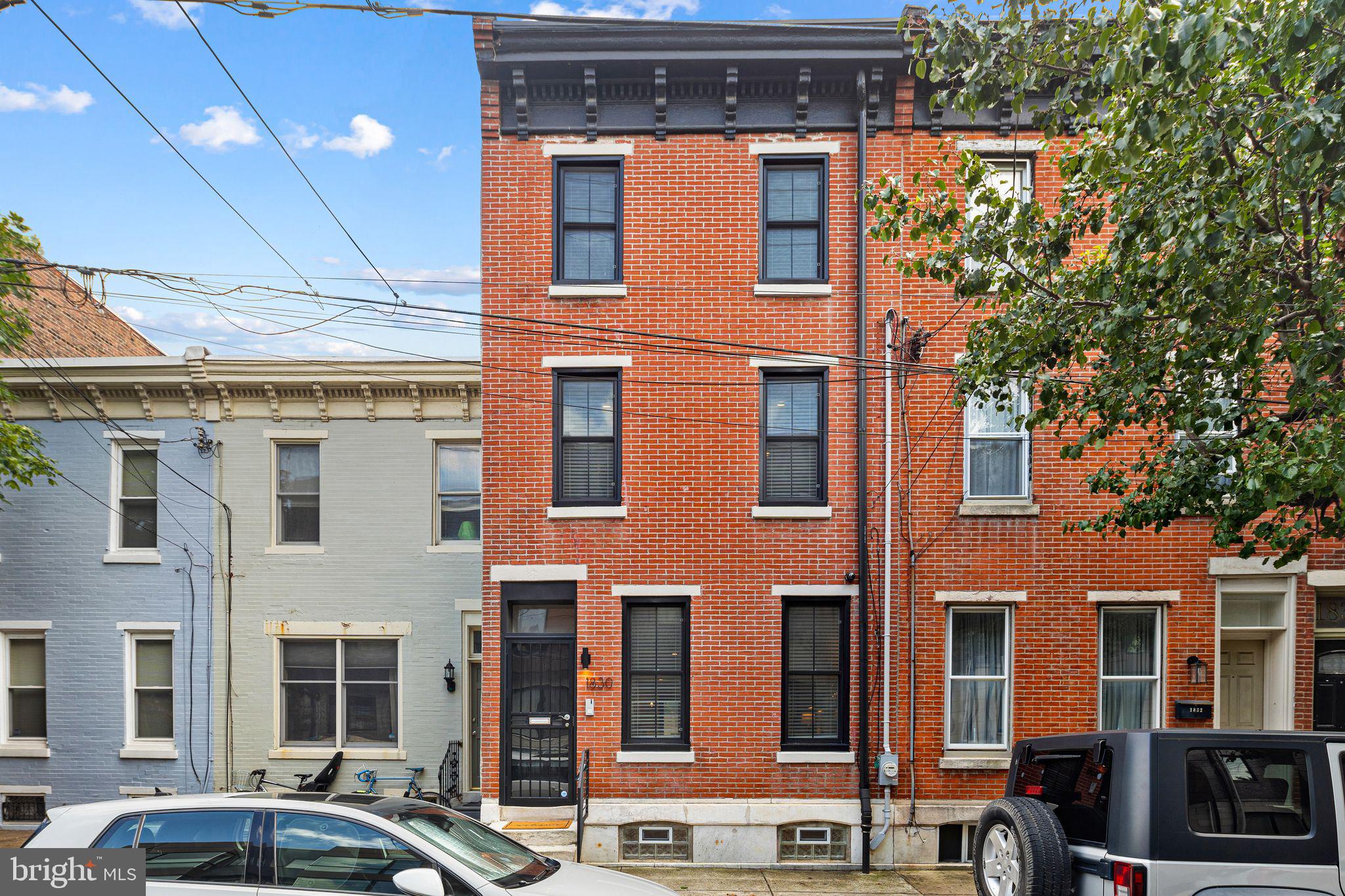 Welcome to 1830 Fitzwater Street - Built in 2018 as a complete gut renovation, this exceptional 3-bedroom, 2.5-bathroom home masterfully blends historic charm with modern luxury. Retaining the original restored brick façade and the original iconic cast iron boot scraper next to the front steps, this home delivers both character and contemporary living. With three years remaining on the tax abatement, it’s an opportunity you don’t want to miss.
As you enter, you’re welcomed by hardwood floors throughout, exposed brick, and detailed crown molding and wainscoting on the first floor. The dining room offers plenty of space for a large table and buffet, perfect for hosting formal dinners or casual gatherings. The massive living room provides endless possibilities and can be rearranged to suit any need—whether it’s a cozy family room, a play area, or an entertainment zone.
The chef-inspired kitchen is a true highlight, featuring a vaulted ceiling, quartz countertops, an 8-foot island with seating for four, a bar and wine rack, and abundant cabinetry for all your storage needs. The space also includes a convenient 1st floor powder room, coat closet, and built-in Bluetooth surround sound speakers—perfect for entertaining or relaxing.
Upstairs, the primary suite is a luxurious retreat with a walk-in closet, a second separate closet, and a spa-like bath featuring a double vanity, walk-in shower, soaking tub, and ample storage. Two additional spacious bedrooms offer multiple closets, and a hallway linen closet provides extra storage. The second-floor laundry room adds convenience, while the shared bathroom includes a double vanity and a shower/tub combo.
The finished basement offers additional living space and extra storage, while dual-zone HVAC ensures optimal comfort across all levels.
The third-floor bonus room is a versatile space that can serve as a home office, workout room, 4th bedroom, or entertainment area. It features a wet bar, mini-fridge, a large closet, and abundant natural light.
Step outside to over 500 sq. ft. of rooftop deck with stunning skyline views and a built-in Bluetooth speaker system—perfect for hosting or unwinding. The spacious rear patio with a garden awaiting your personal touch is ideal for outdoor dining, relaxation, or entertaining.
For peace of mind, the home is equipped with a camera security system, alarm system, and intercom system, offering enhanced convenience and safety.
This home perfectly combines modern amenities, historic charm, and expansive living spaces—making it a must-see! This home is located on the best street in Graduate hospital, only a short walk to Rittenhouse Square and all the best shops, cafes, restaurants, and parks Philly has to offer.