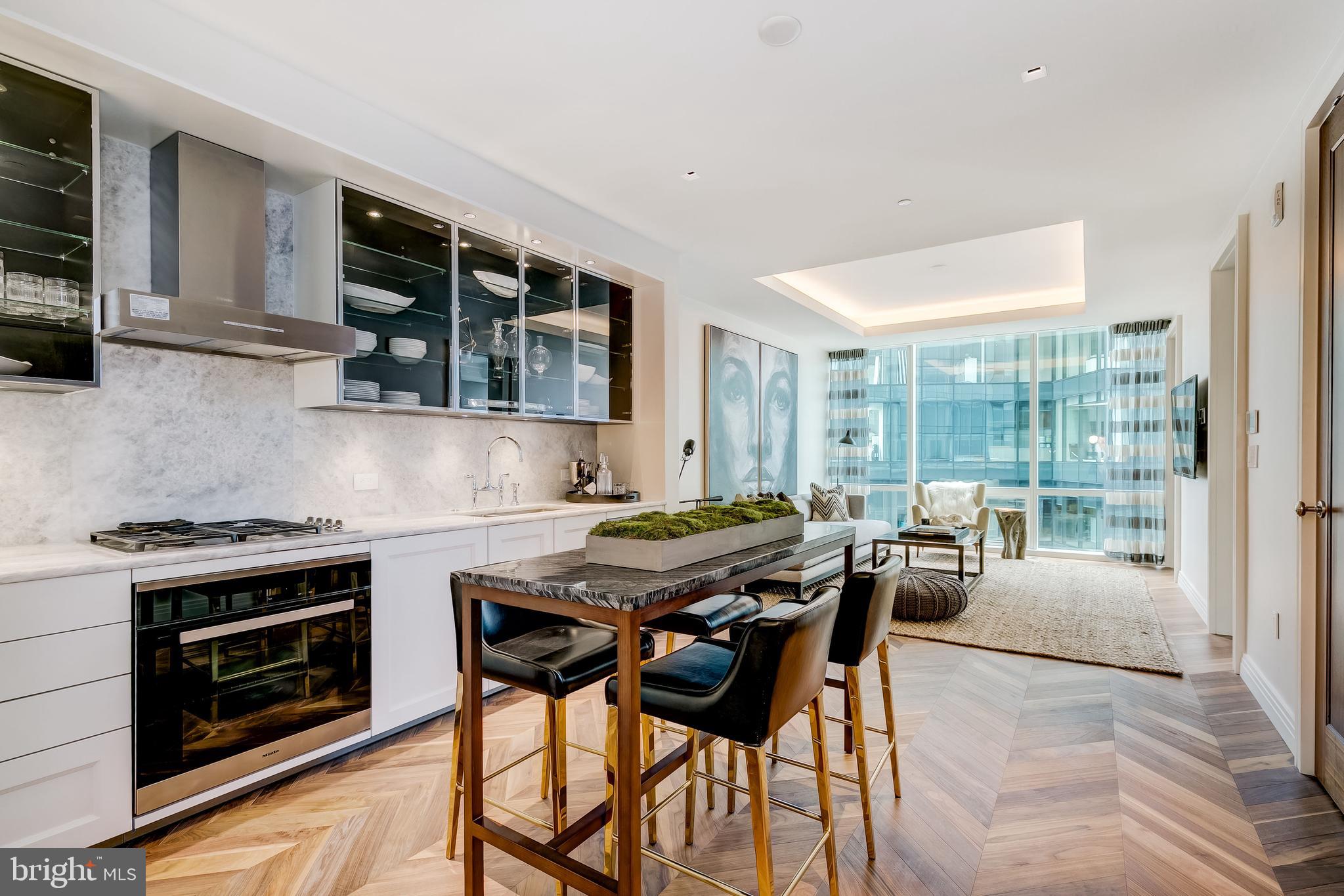 Experience the very best of city living from the 23rd floor of the luxury Four Seasons Private Residences. Located in Baltimore's popular Harbor East, this one-bedroom, one and half bath home offers gracious living with an open layout flowing through the kitchen, dining, and living areas. The 10-foot ceilings and floor-to-ceiling windows bring in bright natural light throughout. Superb quality abounds with walnut herringbone wood flooring, designer light fixtures, and a stunning gourmet kitchen featuring Miele appliances. The primary suite offers a large walk-in closet and marble en suite bath with a dual vanity. As a resident, you’ll enjoy the signature Four Seasons service and amenities that define luxury living, including an indoor infinity pool, spa, meeting rooms, fitness center, and more. As you step outside, you’ll see all Baltimore has to offer with a miles of Harbor walkways, charming shops, award-winning restaurants, waterfront activities, and amazing views.