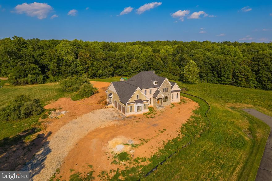 October 2024 Delivery! Full golf membership, valued at $95K, included with this property sale – an unparalleled opportunity! Nestled within the exclusive, gated community of Creighton Farms, this custom-built masterpiece by Novella Homes offers unparalleled luxury and privacy on a pristine 3.05-acre flat lot backing to a serene wooded area. Positioned at the end of a quiet street, this estate embodies seclusion, tranquility, and impeccable craftsmanship. The stately exterior of masonry stone, brick, and Hardi plank siding sets a tone of timeless elegance. A 3-car side-load garage offers ample space and complements the home’s striking architecture. Upon entering, the grand Foyer greets you with 8-inch wide plank hardwood floors that stretch across the open floor plan. Detailed moldings and recessed lighting seamlessly run throughout all three levels. Impressive 10-foot ceilings on the main and lower levels, and 9-foot ceilings on the upper level, create an airy, refined ambiance. The center hall provides a view through to the back veranda, where the lush, tree-lined backyard offers a picturesque backdrop. Flanking the Foyer are the Study and formal Dining Room, setting the stage for elegant gatherings. The Butler’s Pantry, equipped with a sink and beverage fridge, connects the Dining Room to the heart of the home - the Kitchen - a chef’s dream, designed for both everyday cooking and grand entertaining. With 2-inch quartz countertops, abundant custom cabinetry, and a striking 11-foot center island, this space is both functional and beautiful. Outfitted with top-of-the-line appliances, including a side-by-side refrigerator and freezer, a stove with a 6-burner gas/propane cooktop, a stunning metal range hood, built-in microwave, and dishwasher. A spacious walk-in pantry and a Scullery, complete with a beverage fridge, sink, and dishwasher, ensure everything you need is at your fingertips. The Kitchen flows into the Great Room, where beamed ceilings and a fireplace create a cozy yet expansive space. A wall of sliding glass doors provides seamless access to the covered veranda, overlooking the private backyard. Adjacent to the Kitchen, a Morning Room with a masonry propane fireplace offers an intimate space for quiet reflection or casual dining, also with access to the veranda. The Family Foyer offers a practical and stylish entry from the garage, leading to a well-designed drop zone with built-in cubbies—ideal for keeping daily life organized. Just off the Family Foyer, a sunlit room with pocket doors provides the perfect space for a Home Office or Hobby Room, offering a peaceful retreat for work or creative projects. The main-level Primary Suite is a sanctuary of luxury and comfort, with direct access to the covered veranda. The ensuite bath features dual sinks, a soaking tub, a step-in spa shower, and a massive walk-in and walk-through closet, offering a private oasis. The upper level features an open Family Room with built-in cabinetry and shelving. Three spacious Bedrooms, each with walk-in closets and attached Bathrooms, provide ample space and privacy for family or guests. The lower level is designed for entertainment and relaxation. The expansive Rec Room and Game Room, with a dual-sided gas fireplace and a wet bar featuring quartz countertops, a beverage fridge, dishwasher, and sink, are perfect for hosting gatherings. Additional spaces include a Billiard room, a Bedroom with a large closet serviced by a full Bathroom, an Exercise Room, and Media Room. A stairwell off the Rec Room offers convenient walk-up access to the backyard. This exquisite home is a rare offering in the sought-after Creighton Farms community, where luxury living meets unparalleled privacy and comfort. Certain amenities highlighted in the listing and photos are exclusive to Creighton Farms Golf and Country Club memberships, which are separate from HOA dues. Access to these amenities is determined by the selected membership level.