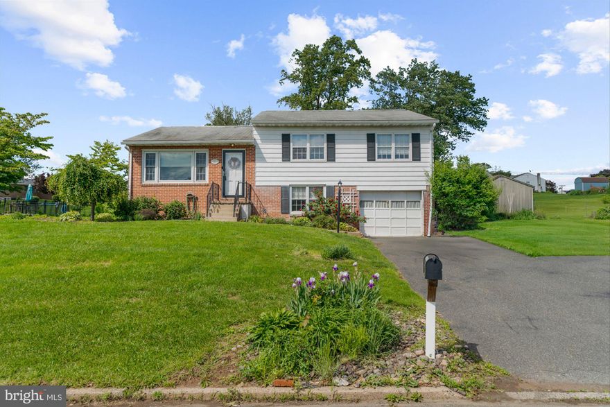 Solid timeless three bedroom home with hardwood flooring throughout, fully fenced yard and one car garage. The bright living room with plentiful windows carries into the eat-in kitchen with solid wood cabinets and access to the beautiful fully fence back yard with expansive concrete-stamped patio and fire pit.  The hardwood floors carry through the upper level (under hallway carpet I'm sure), which consists of three amply-sized bedrooms and a hall bath with the fun original tile.  A family room and convenient laundry room on the lower level with a partial basement for plenty of storage beneath that.  Lots is offered with this property: central air, radon remediation, on-site water and public sewer, country feel yet a community to be built across the street, which will make taking a walk a bit easier and safer.  Really a great home!