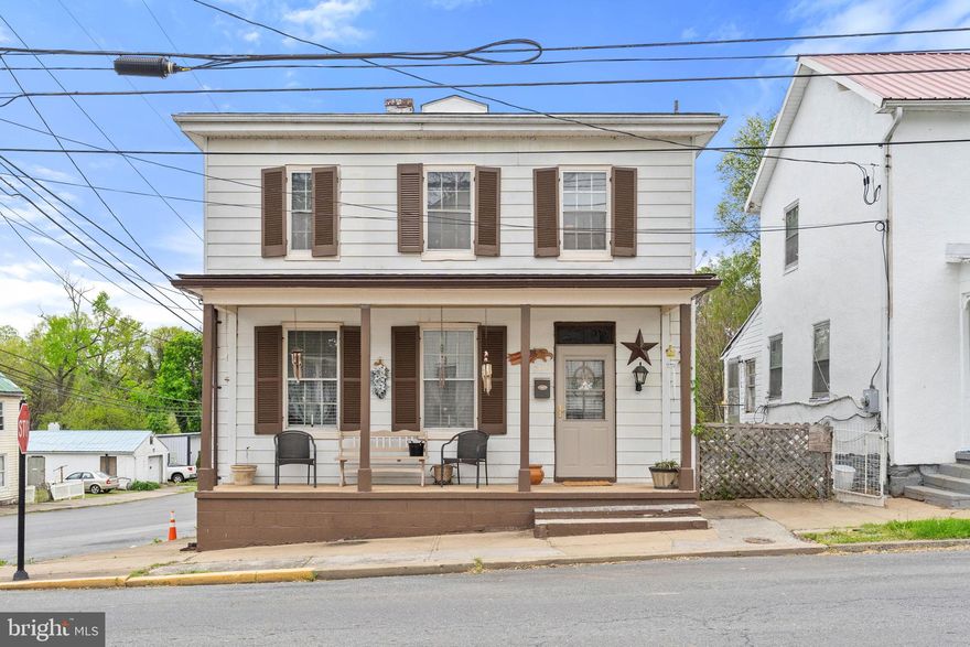 Step into history with this 1870 Colonial home, just one street over from Historic Charles Town's bustling main street. While it needs attention, this property offers fantastic potential. Situated on a corner lot with a quaint backyard, it provides a peaceful escape within the city. Inside, discover a spacious family room, a formal dining room, and an eat-in kitchen awaiting your personal touch. The main level also features a convenient laundry room and half bath for added practicality. Upstairs, three bedrooms and a vintage-inspired bathroom with a classic claw foot tub await. Although the three fireplaces are currently out of commission, they hold promise for restoration, bringing even more character and warmth to the home. With a compact lot size, maintenance is a breeze, leaving more time to relax on the expansive front porch. Explore downtown amenities, dining, and shopping within walking distance, immersing yourself in the rich history and culture of Charles Town.