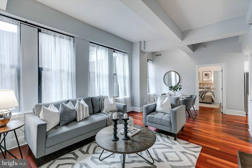 Enjoy deluxe city living in this bright and sunny one bedroom residence at the Ellington. The living and dining areas offer soaring ceiling heights, gleaming hardwood floors, and  oversized windows that fill the interior with an abundance of light. The gourmet chef s kitchen features POGGENPOHL cabinetry, stainless steel appliances, KOHLER fixtures, and CAPAO BONITO granite countertops. The bedroom is generously proportioned and has good closet space. The spa-like bathroom boasts White GIOIA marble tile flooring, a ceramic sink with storage vanity, and a spacious storage/linen closet. Included in the condo fees are central air and heating, water and sewer, a 24 hour concierge, an on-site fitness center, and a residents lounge. Valet parking is available next door in a public garage for an additional fee. Perfectly situated in the Rittenhouse and Avenue of the Arts area,   this coveted pet-friendly residence is just steps from Jefferson University, Rittenhouse Square, fine dining, boutique shopping, vibrant nightlife, and world-class cultural attractions. With easy access to major public transportation, 30th Street Station, Penn, Drexel, and HUP/CHOP hospitals, this home offers both luxury and convenience. ***Photos are from a different unit with similar finishes and identical floor plan.