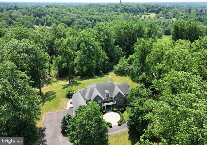 Nestled amidst the beauty of summer flowers and mature blooming trees, is 3145 Paper Mill Rd. A custom Stone Manse that stands as a true architectural masterpiece. From the moment you arrive, the quality of craftsmanship and design elements are unmistakable, promising a lifestyle of unparalleled elegance and sophistication.

This magnificent residence is situated on over 3 acres of pristine manicured lawns and professionally landscaped gardens, offering a tranquil retreat from the hustle and bustle of everyday life. With a total home footprint of approximately 10,000 square feet, the floor plan is both timeless and modern, boasting an open and expansive layout that's perfect for both everyday living and grand entertaining.

Imagine starting your day with a leisurely stroll through the beautiful grounds of the Pennypack Ecological Trust, with its trails for walking, running, and biking, just moments away. Privacy and serenity abound, complemented by thoughtful features such as a first floor master suite, gourmet kitchen , a timeless and modern expansive floor plan, a whole house generator and radiant flooring throughout the first floor. Ascend the curved floating stair case to  the second floor,  that showcases all ensuite bedrooms. Providing luxurious comfort and convenience for family and guests alike.

The lower level is designed for entertainment and storage, offering endless possibilities for creating the ultimate recreational space. This four-story custom build exudes unsurpassed quality in craftsmanship, inviting you to experience the grandeur and refinement of 3145 Paper Mill.

Located in the coveted Stonegate neighborhood of sought-after Huntingdon Valley, this home offers more than just luxurious living—it provides a lifestyle of unparalleled convenience and opportunity. Enjoy easy access to major highways and rail lines, an award-winning school system, and an abundance of cultural venues and experiences just waiting to be explored.