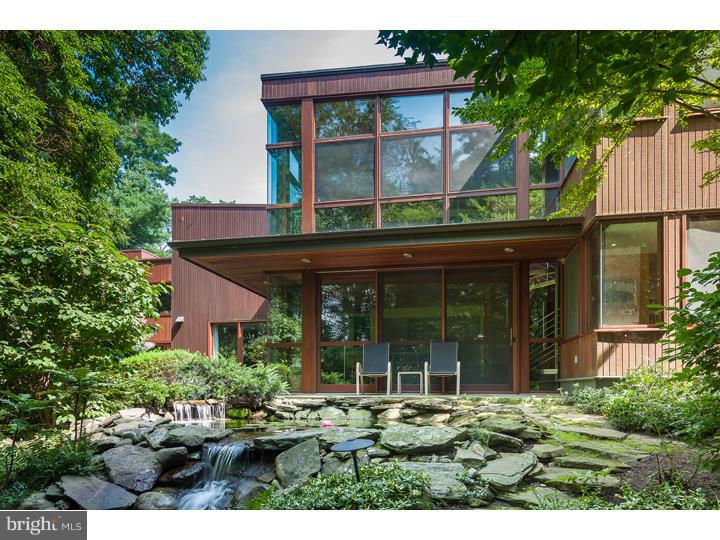 This spectacular contemporary bordering the Philadelphia Cricket Club's Chestnut Hill golf course offers complete privacy on 1.2 acres. The bright, open floor plan is the perfect setting for entertaining guests, displaying art, and for festive holiday gatherings. Perfectly scaled rooms give this large home a warm, inviting feel while the exquisite design and materials make a bold statement. Special features include beautifully crafted woodwork throughout, abundant closets, and many large windows and atrium doors that provide access to the gardens and gorgeous views from every room. A 2-story, 4-room addition includes a garden room, family room, TV room, and sun room, all with custom gas fireplaces. The fabulous kitchen has custom wood cabinets, a center island, granite counters, and stainless steel appliances, including a pro-style 6-burner Viking stove and Sub-Zero fridge. A separate prep area has an extra dishwasher, sink, and storage - great for large parties. The master suite offers a very large bedroom, 6 closets, and a private ceramic tile and marble bath with shower and sauna. The four additional bedrooms and two full baths are all on the second floor. Outside, you'll enjoy a beautiful slate patio, in-ground pool, lily pond with waterfall, and lush wooded landscaping. A unique property in a premier location that feels like a vacation home, but with easy access to the city. Co-listing agent is related to sellers.