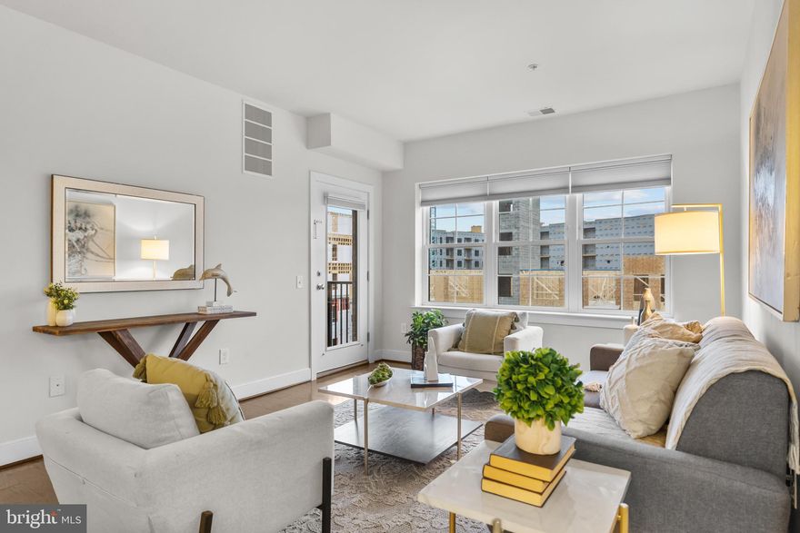 Welcome to the Lofts at Metro West, just steps to the Vienna Metro Station and with fast access into Downtown DC or into Reston/Loudon Tech Corridor.  There is an abundance of coffee shops, grocery stores, shopping, and many events held in historic Vienna, VA, which is just a short drive-away. This sought-after Cannes Model offers 1,256 square feet of beautifully finished living space, a private covered balcony, and convenient tandem garage parking. This spacious residence is filled with upscale, modern upgrades, including elegant 5-inch oak hardwood flooring that flows throughout the home. Prewired for wall mounted TVs in each room, new Graber window coverings (cordless) inc. blackout shades for the bedrooms. New ceiling fan with remote. Newer appliances and HVAC just serviced.  It is ready for your move-in.   You'll also enjoy easy access to downtown Fairfax, Vienna, Mosaic District, and Tysons Corner. Fitness enthusiasts will love the nearby Jim Scott Community Center, offering complimentary fitness facilities and classes for MetroWest residents. A low monthly condo fee includes water and trash removal. 

The gourmet kitchen is a true highlight, featuring stunning quartz countertops, a sleek porcelain backsplash, rich maple cabinetry, stainless steel appliances, and thoughtfully designed pantry space. A separate laundry closet with a full-sized washer and dryer adds both convenience and extra storage.

The generously sized primary suite provides a relaxing retreat, complete with a luxurious ensuite bathroom boasting a double-sink vanity, granite countertops, and a custom walk-in closet with an organized shelving system.

Residents of The Flats at MetroWest enjoy exclusive access to the Providence (Jim Scott) Community Center, offering resort-style amenities including a fully equipped fitness center, game room, business center, and basketball court, day care, art programs, senior programs, and:
Fitness Room
Billiards Room
Teen Room
Sensory Room
Senior Room
Kitchen
Multipurpose Rooms
Multiuse Computer Lab/Sound Studio
Art Room
Glass Recycling Drop Off

Ideally located just steps from the Vienna Metro, Pan Am Shopping Center, Mosaic District, Fairfax Circle, and major commuter routes including I-66 and I-495, this exceptional home combines upscale living with unbeatable convenience.  Minutes in D.C. and to major employers. Don’t miss the opportunity to experience this beautiful home in person—schedule your private tour today.