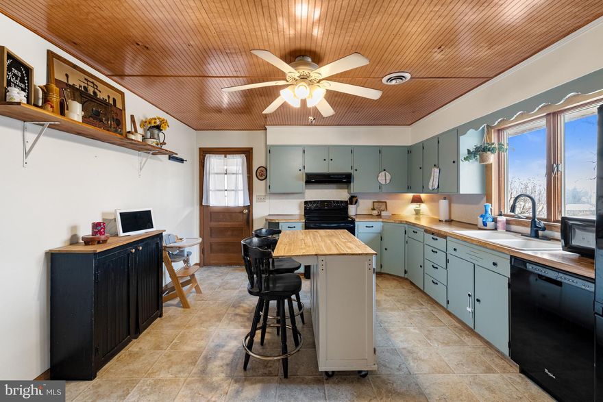 Welcome to peaceful country living!  This solid brick ranch home sits on 1.41 beautiful acres and offers space, comfort, and versatility.  The main level features three spacious bedrooms and two full bathrooms, along with a bright dining room and functional kitchen perfect for everyday living and entertaining. The partially finished basement provides even more living space, including a large living room and dedicated office or playroom area.  There's also plenty of unfinished space for storage, hobbies, or future expansion.  A huge wood stove in the basement is capable of heating the entire home, offering both warmth and efficiency, in addition to central heat and air for year round comfort.  Behind the main house, you'll find a separate guest home complete with one bedroom, one bathroom, living room, and kitchen.  This additional dwelling is ideal for extended family, guests, rental income, or a private office setup. If you're looking for space, flexibility, and quiet country surroundings, this property checks all the boxes... call for a tour today!