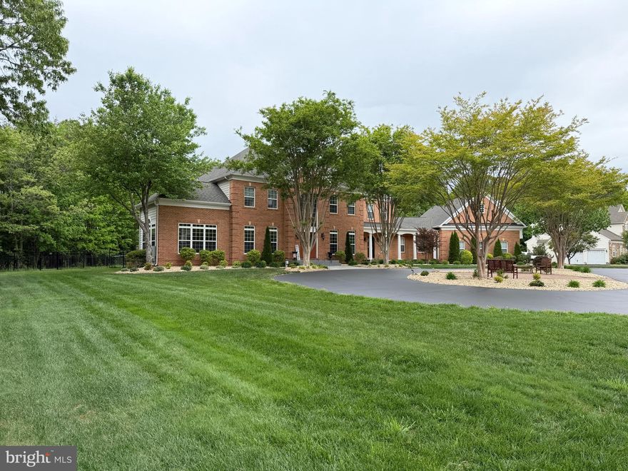 COMING SOON: High-quality, custom 8,600+ SF multi-generational estate on 2 acres in mid Calvert County. This brick-front home features 5 bedrooms and 5.2 baths across three finished levels. The main level offers a private in-law wing with a screened porch and separate entrance, alongside a large eat-in kitchen, separate dining, family room, executive office with custom wood feature walls, and a morning room with 12-ft ceilings and marble floors; hardwood floors throughout most of this level. The upper level includes the owner's suite (tray ceiling, fireplace, coffee bar), three additional large bedrooms with two more full baths. The walk-up lower level provides a second full kitchen, a tiled shower bath(perfect for pool), media room, billiards area, and a built-in entertainment area with a fourth fireplace. Outdoor living features a covered stone patio plus open play areas around the 20'x40' heated chlorine pool (convertible to salt) with a tanning shelf, diving board, and stone waterfall, plus two large party pavilions. A separate fenced area is perfect for the pets. Two outbuildings on slab (36'x26', 24'x26') offer four additional garage bays, shop space, water, and power. Home warranty conveys. Showings begin soon!