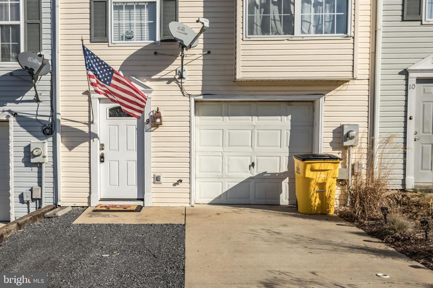 Beautiful three story townhome in Hedgesville Hills and NO HOA fees!  Excellent starter home and buy for much less than you can rent.  Two oversized bedrooms and full bath are on the third level.  Main level features a kitchen/dining combo and all appliances convey.  Main level also has a half bath and a family room that walks out to a fenced patio. New LVP flooring in the downstairs and in the full bath.  Separate large laundry room has washer and dryer that also convey.  Seller to leave wired security cameras for the new owner.  Plenty of parking in the large one care garage and two additional driveway spots.  Close to commuter routes and move in ready!