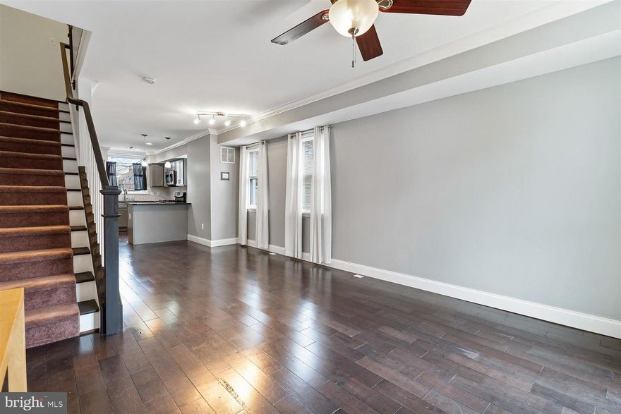 This 2 bed 2.5 bath porch front home  in the heart Locust Point cannot be overlooked. Hard wood floors, powder room  on the first floor with large eat in Kitchen with stainless steel appliances.  End unit make this home with 12 windows for tons of natural light! 13 feet wide with a large deep basement that can be easily finished.  Second floor has 2 beds both with full baths.  2nd bedroom is great for the home office or Nursery.  Washer Dryer on second floor.  Private parking pad in rear of home.