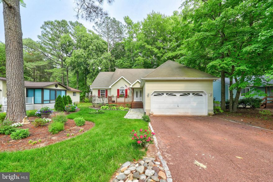 Welcome to this serene single-level contemporary home nestled on a peaceful cul-de-sac in the charming Ocean Pines community, just a short distance from the vibrant coastal city of Ocean City, MD. This thoughtfully designed residence boasts a harmonious blend of modern style and tranquility, creating a perfect oasis for those seeking a peaceful coastal retreat. As you approach the property, you are greeted by beautiful landscaping that frames the home, and an inviting exterior. The interior of this home creates a sense of space and openness created by the high vaulted ceilings, which amplify the abundant natural light that enhances the overall ambiance of the home. The neutral color palette and stunning hardwood floors contribute to the contemporary aesthetic and soothing atmosphere. The heart of the home is the updated kitchen, featuring gleaming marbled quartz counters, peninsula island, refinished white cabinetry, new wall oven, and gas cooktop that seamlessly blend style and function. Adjoined to the kitchen, is a cozy breakfast nook and wide-open family room adorned with high ceilings and wood burning fireplace. Pocket doors reveal a peaceful sitting room, ideal for relaxing with a good book or engaging in intimate conversations. A lovely sunroom creates a tranquil space that connects the indoors with the natural beauty of the outdoors. Surrounded by large windows that provide breathtaking views of the private rear yard, the sunroom invites you to bask in the warmth of natural light and enjoy the ever-changing seasons. A convenient study allows for a quiet place to work from home. The generous primary suite features a private en-suite bathroom with relaxing soaking tub. Two additional bedrooms and a full bath are equally inviting, providing comfort and privacy for family members or guests. The property's location on a cul-de-sac along the 14th fairway adds to the peacefulness of the setting, providing a sense of privacy and minimal traffic. Additionally, the proximity to Ocean City, MD, with its lively atmosphere and beautiful beaches, offers endless opportunities for entertainment, dining, and recreational activities. Additional upgrades include a gas grill plumbed with gas hookup, a new roof being installed, encapsulated crawlspace and dehumidifier, new kitchen sink and faucet, and upgraded spice drawer.